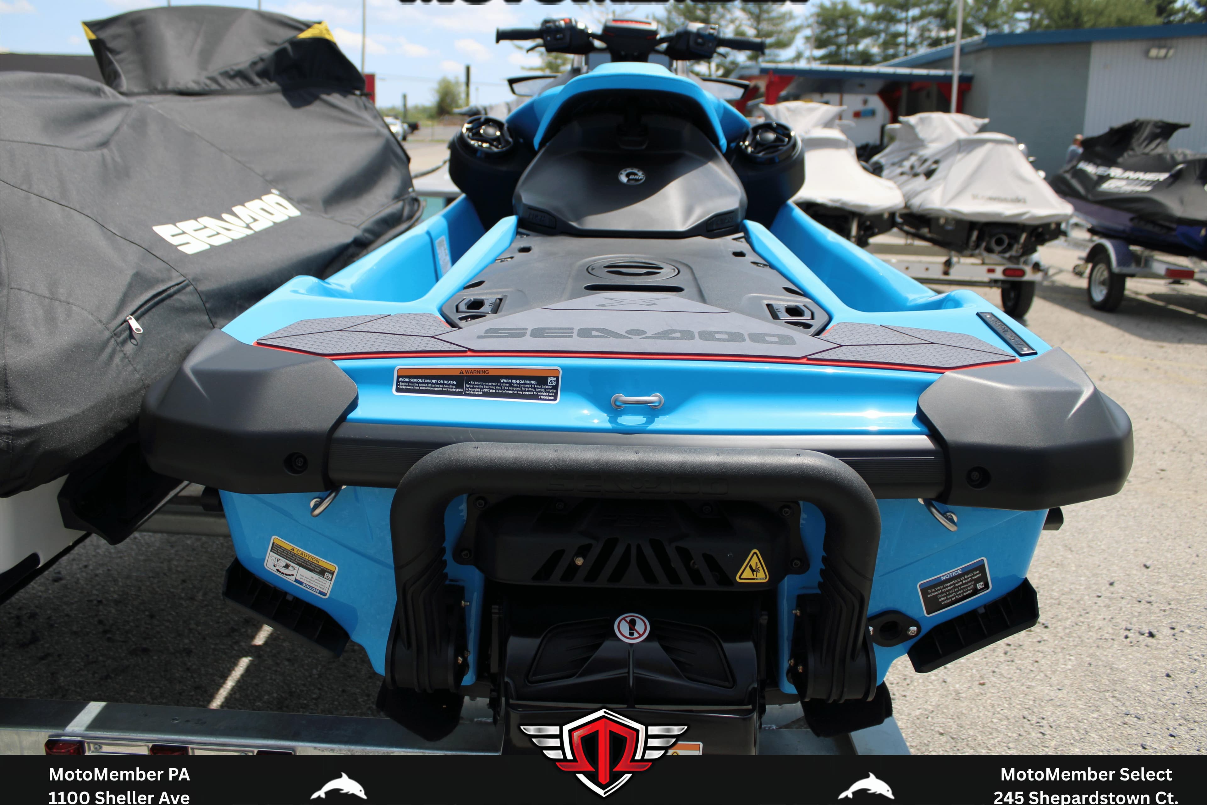 2026 Sea-Doo RXP-X 325 jet ski in vibrant blue, rear view on display.