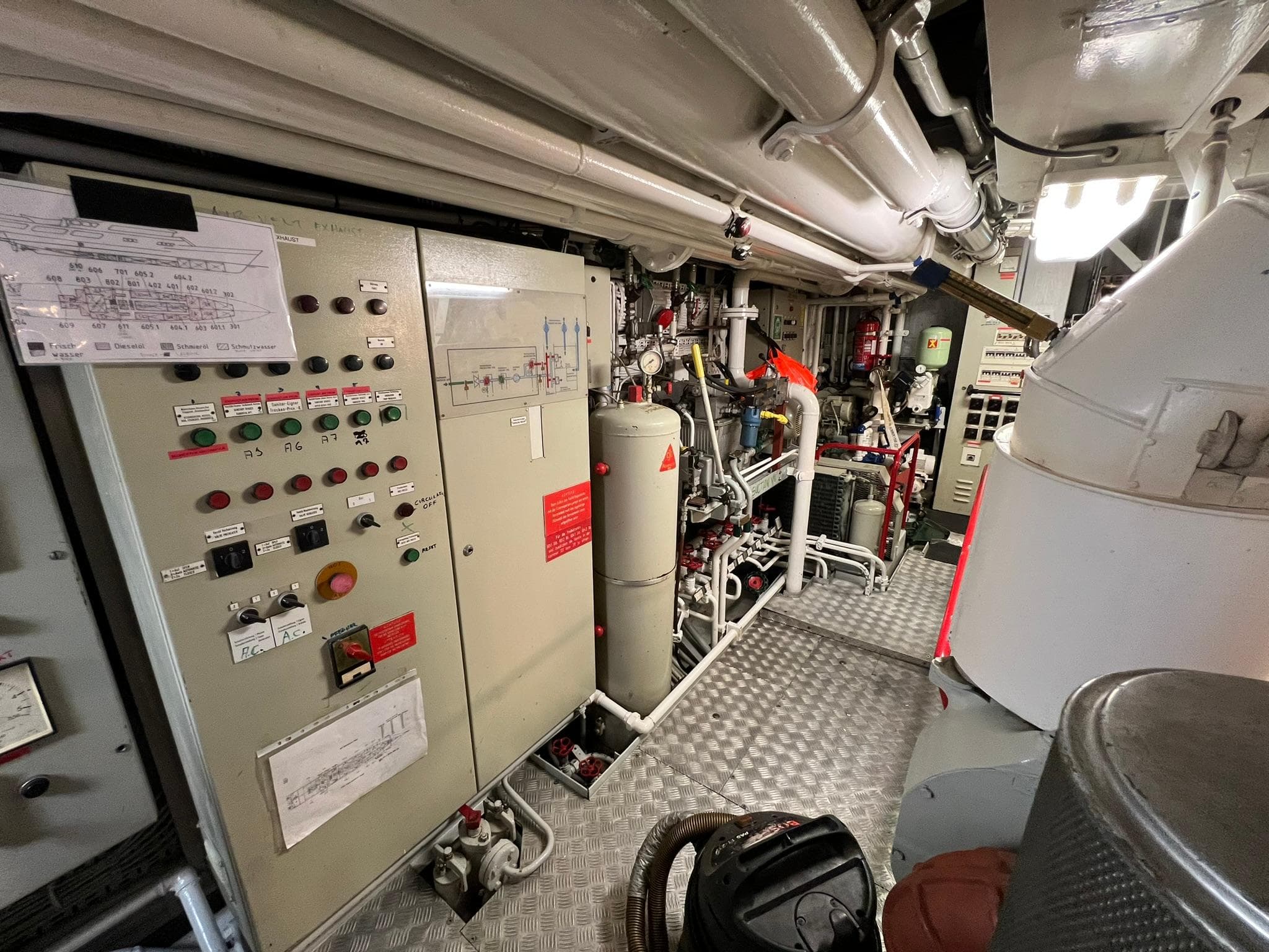 Engine room of 1982 Custom Displacement Twin Screw with control panels and machinery.