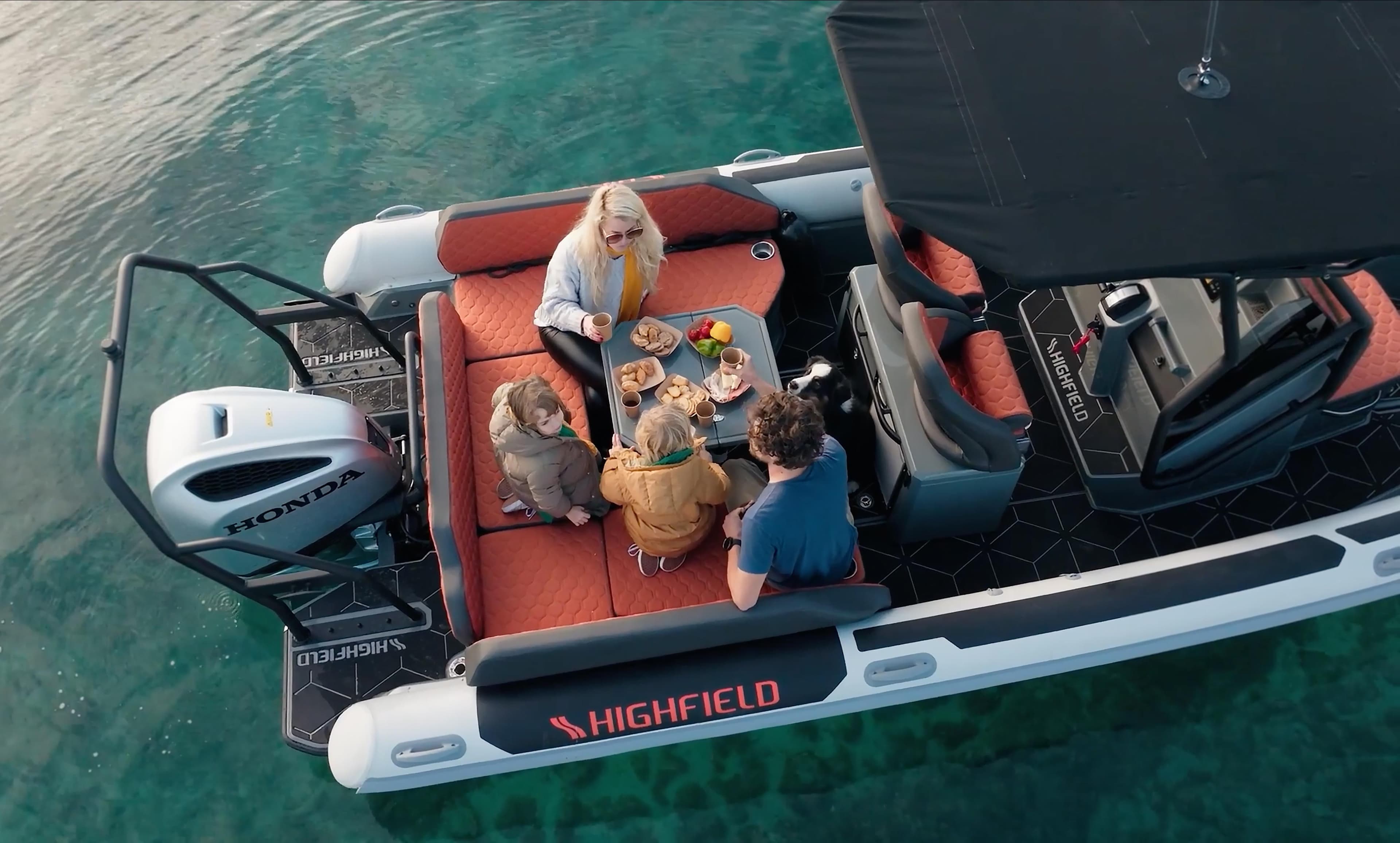 2025 Highfield ADV7 boat with people enjoying a meal on the water.