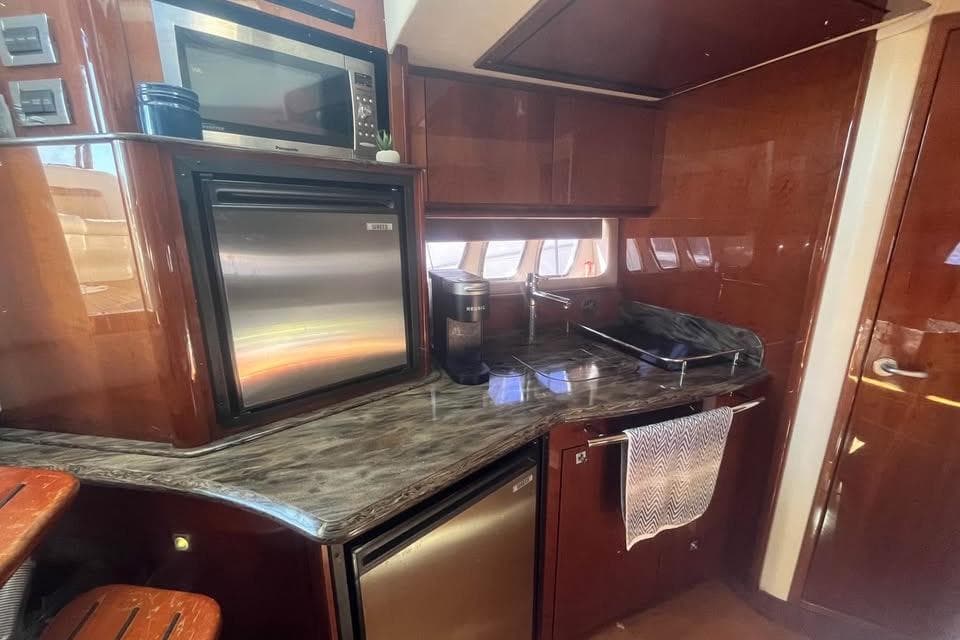 Luxurious 2012 Sea Ray 390 Sundancer yacht kitchen with modern appliances and sleek design.