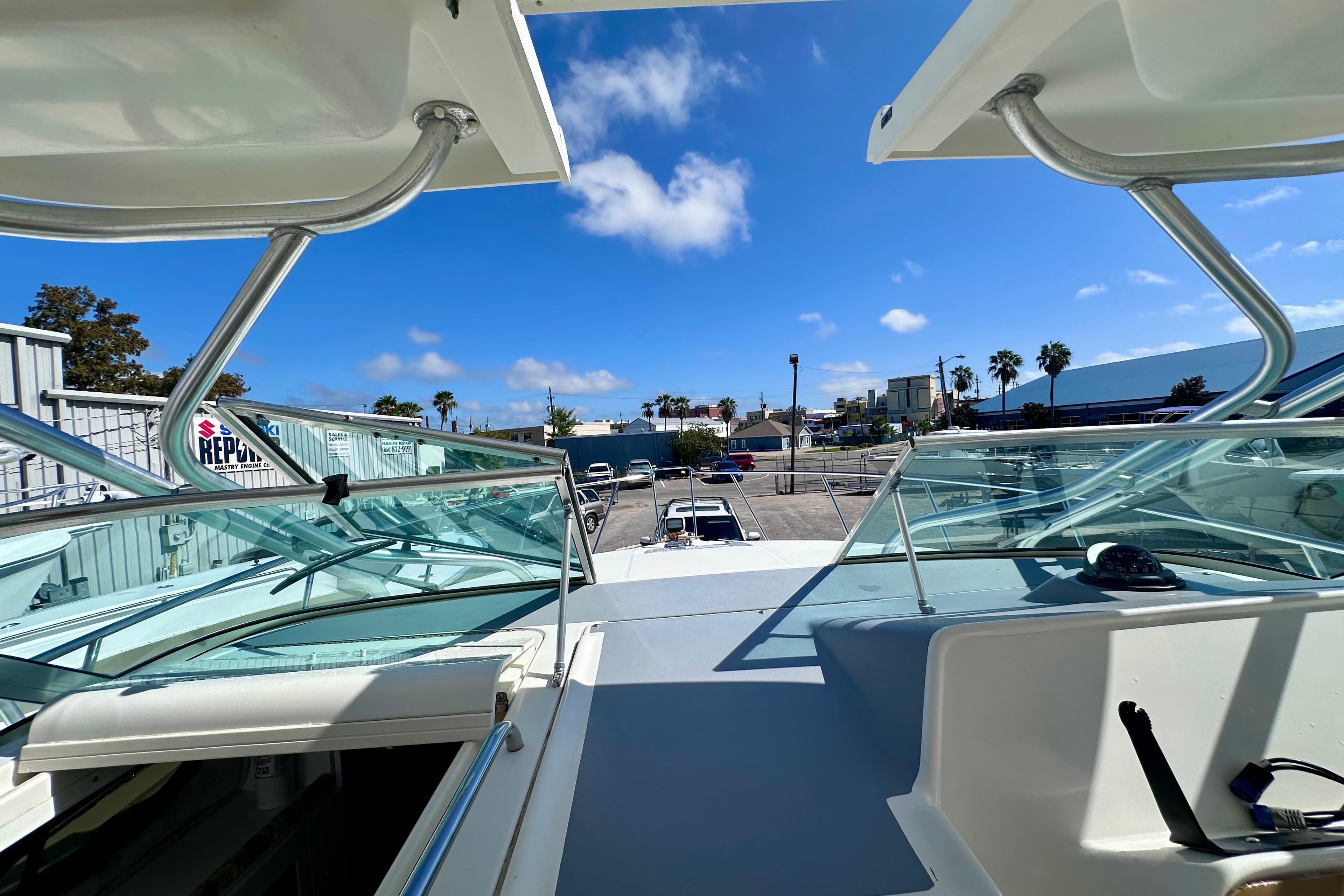 2001 Wellcraft 290 Coastal boat deck view with clear skies and urban backdrop.