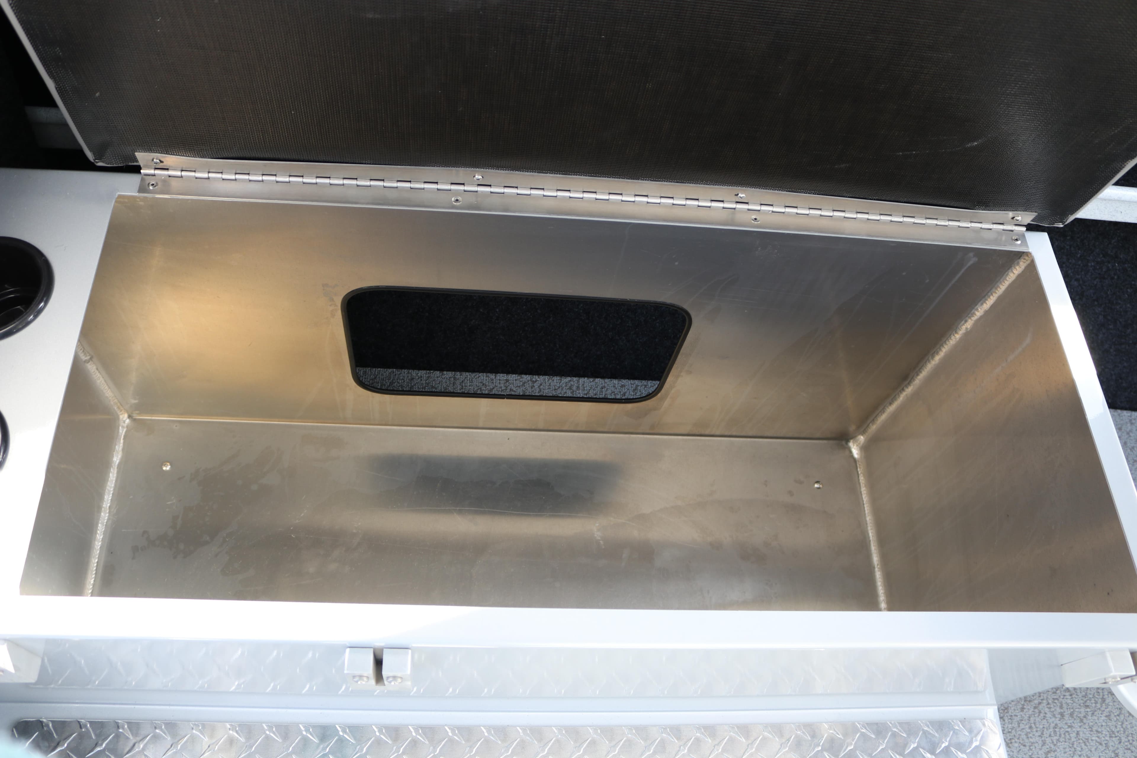 Open storage compartment in 2026 KingFisher 2425 Escape HT boat.