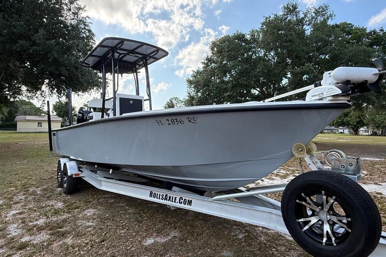 2017 Dorado 25 SE boat on trailer, parked outdoors under a cloudy sky.