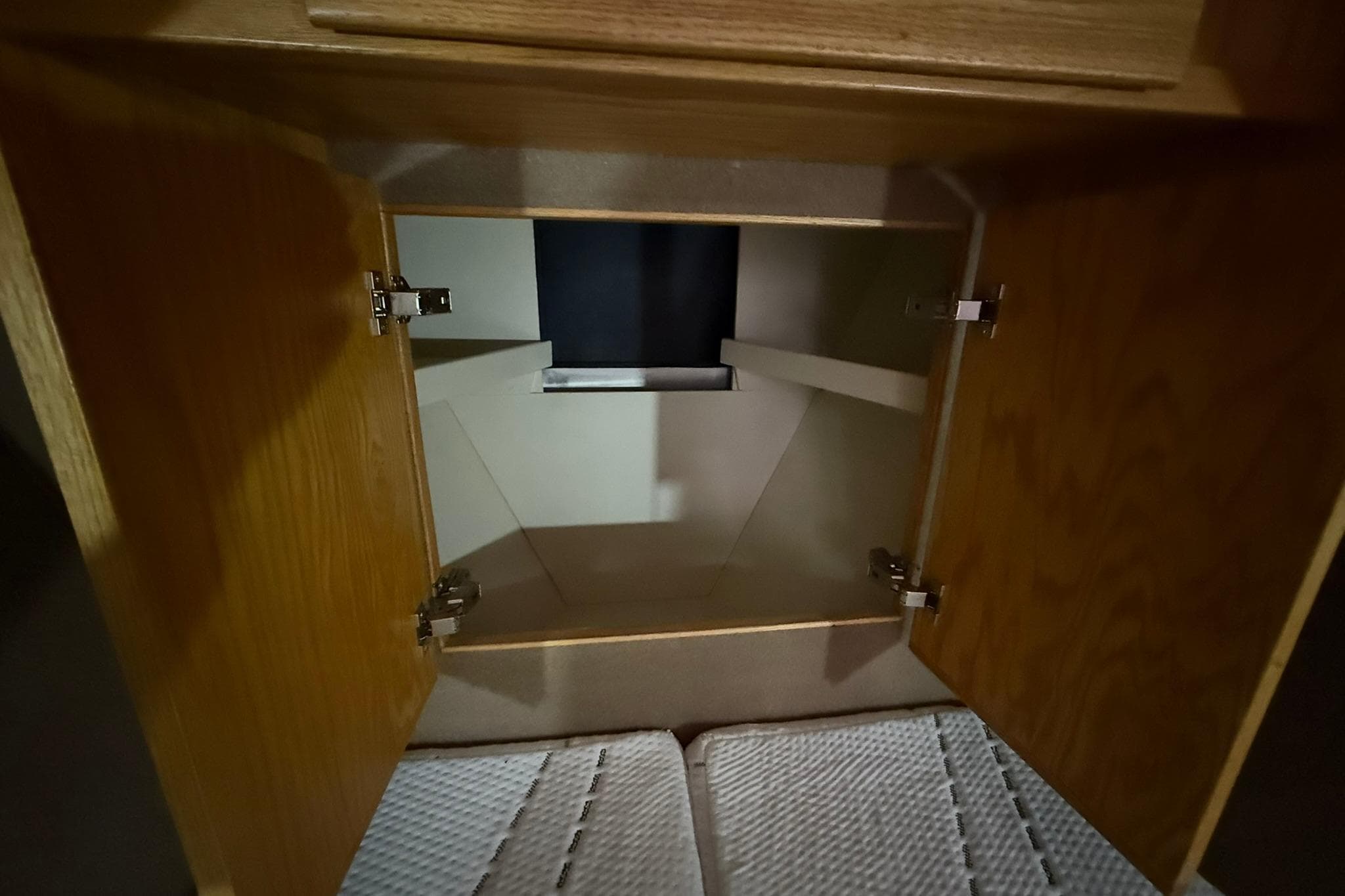 Open wooden cabinet inside 2013 Eco-Trawler 33 boat, showcasing interior storage space.