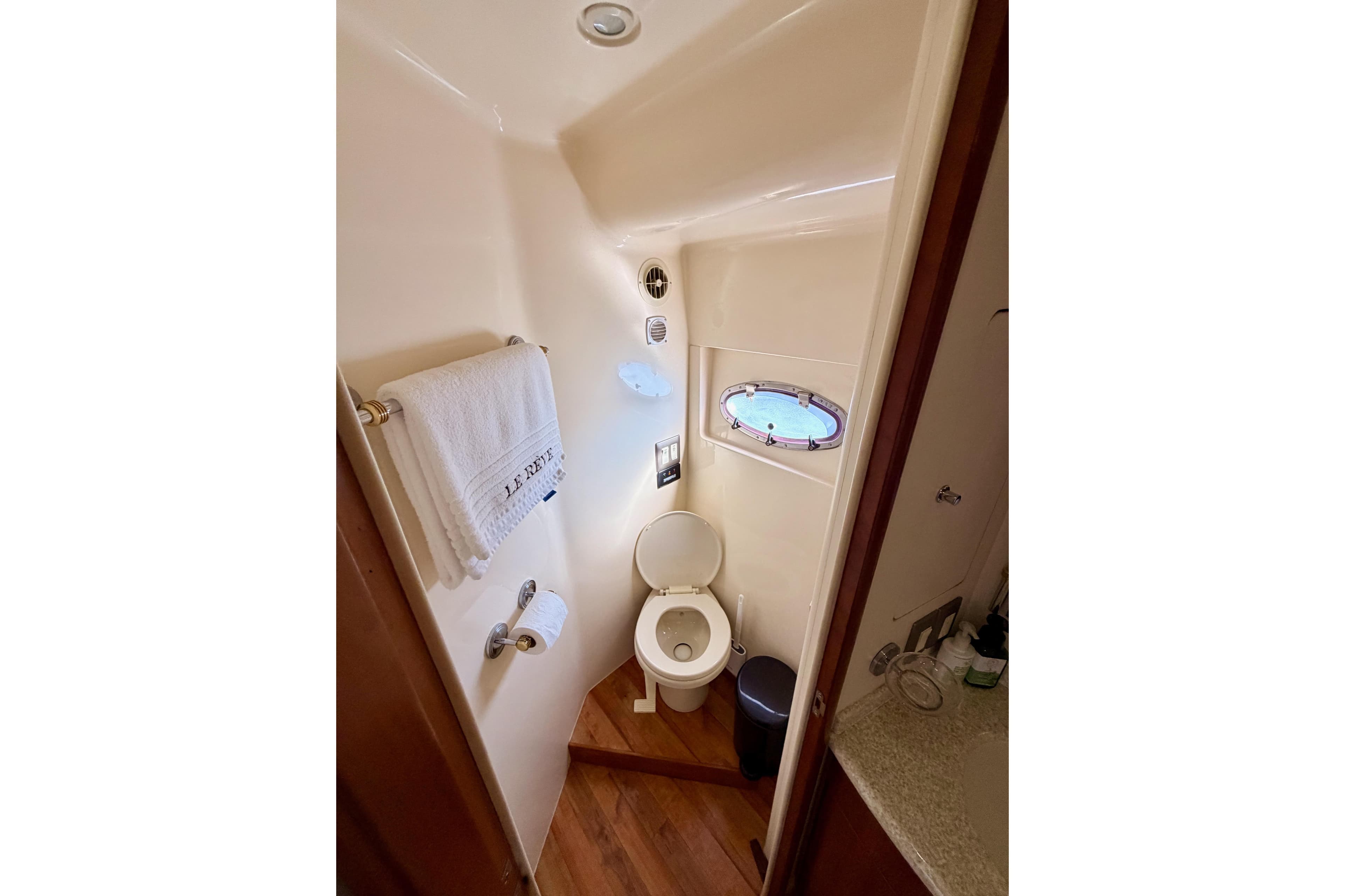 Bathroom interior of 1999 Carver 530 Voyager Pilothouse yacht with porthole window.