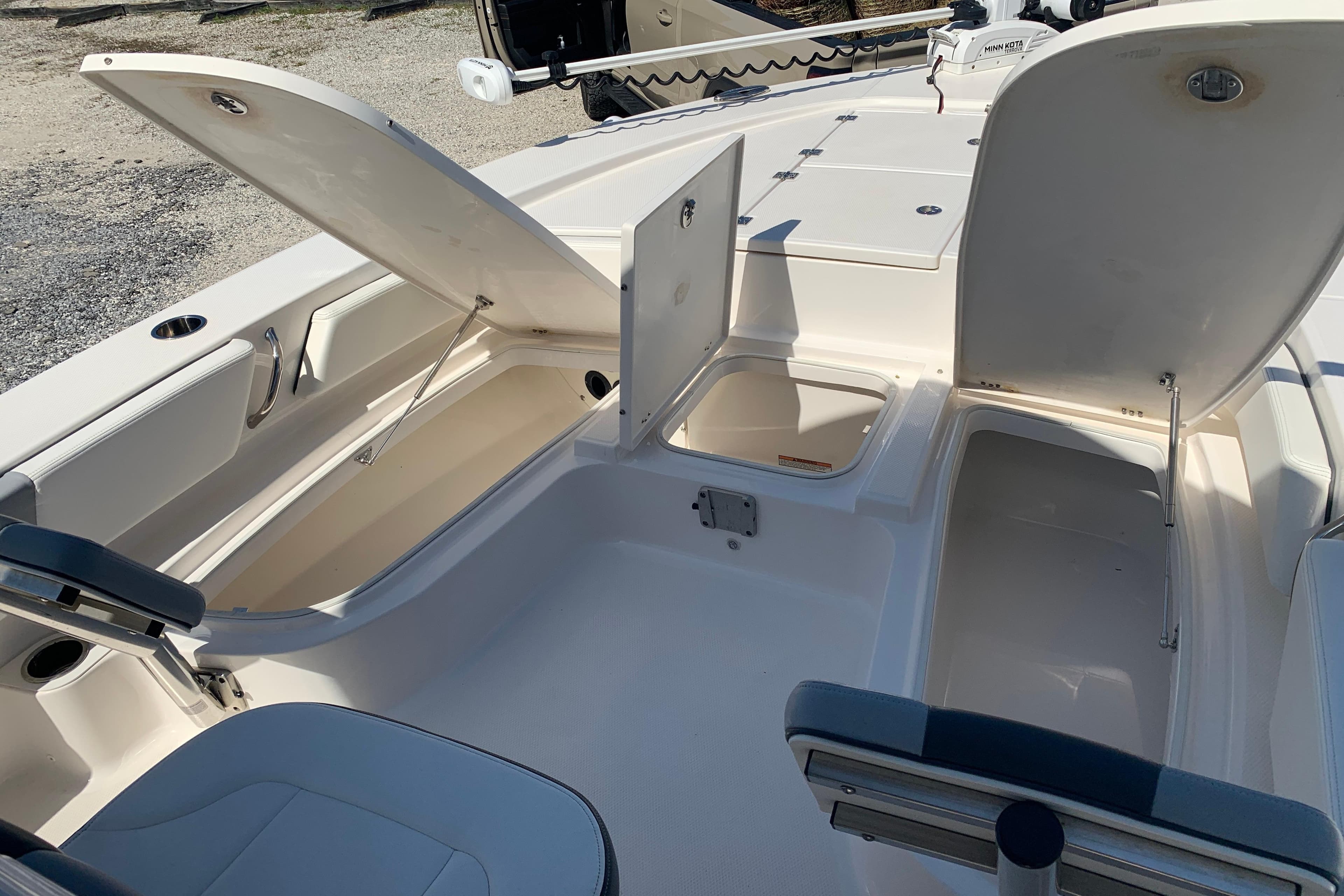 2022 Robalo 246 Cayman boat interior with open storage compartments.