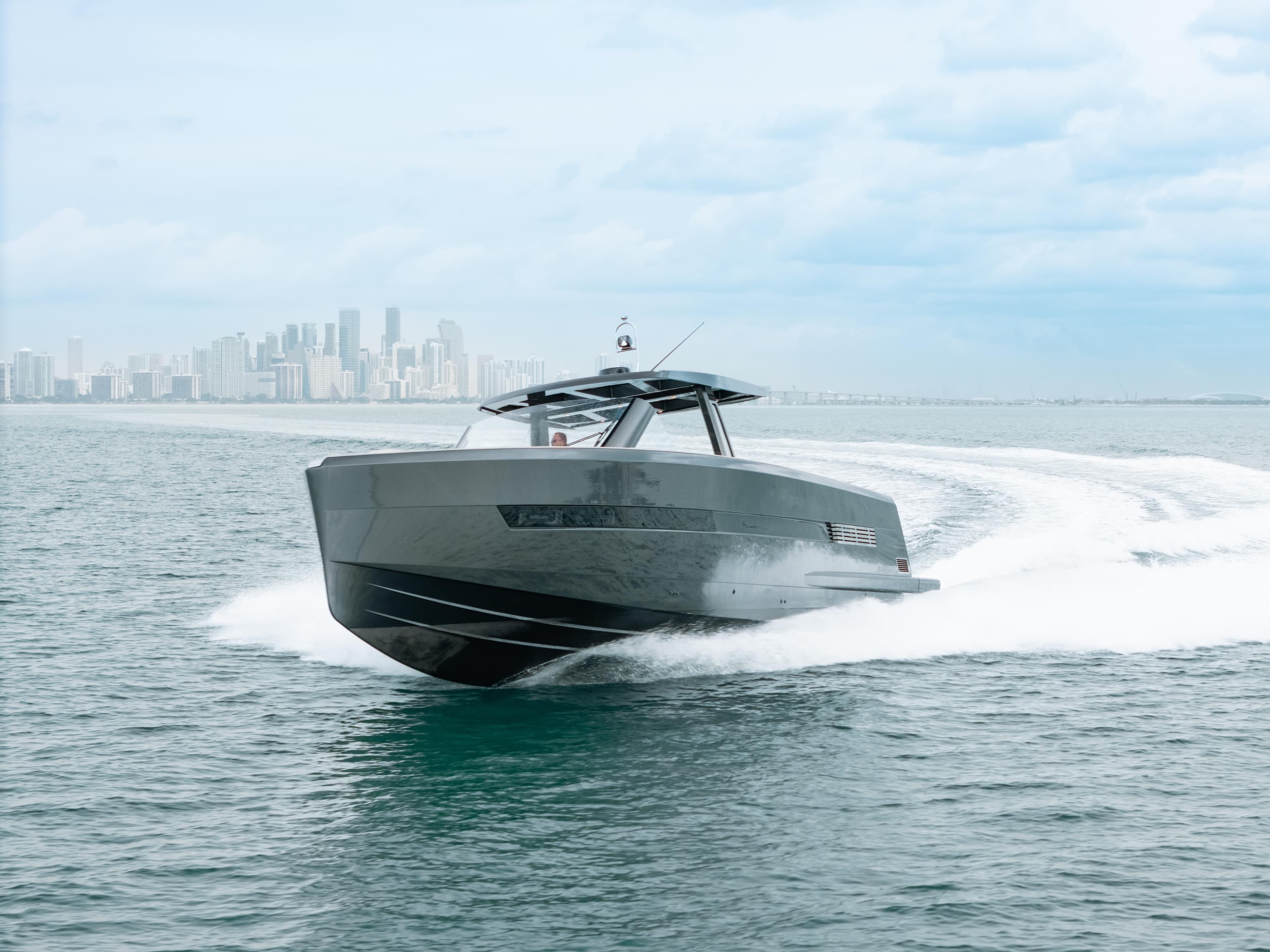 2022 Fjord 52 Open yacht cruising on ocean with city skyline in background.