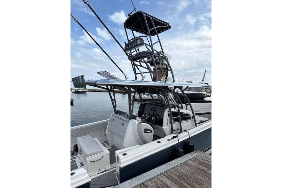 2020 Nor-Tech 390 Sport Center Console boat docked, featuring a sleek design and fishing tower.
