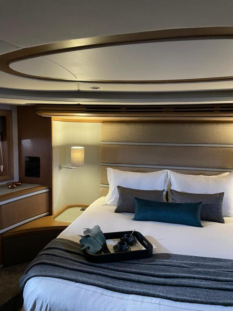 Luxurious bedroom interior of 2003 Azimut 98 Leonardo yacht with elegant decor.