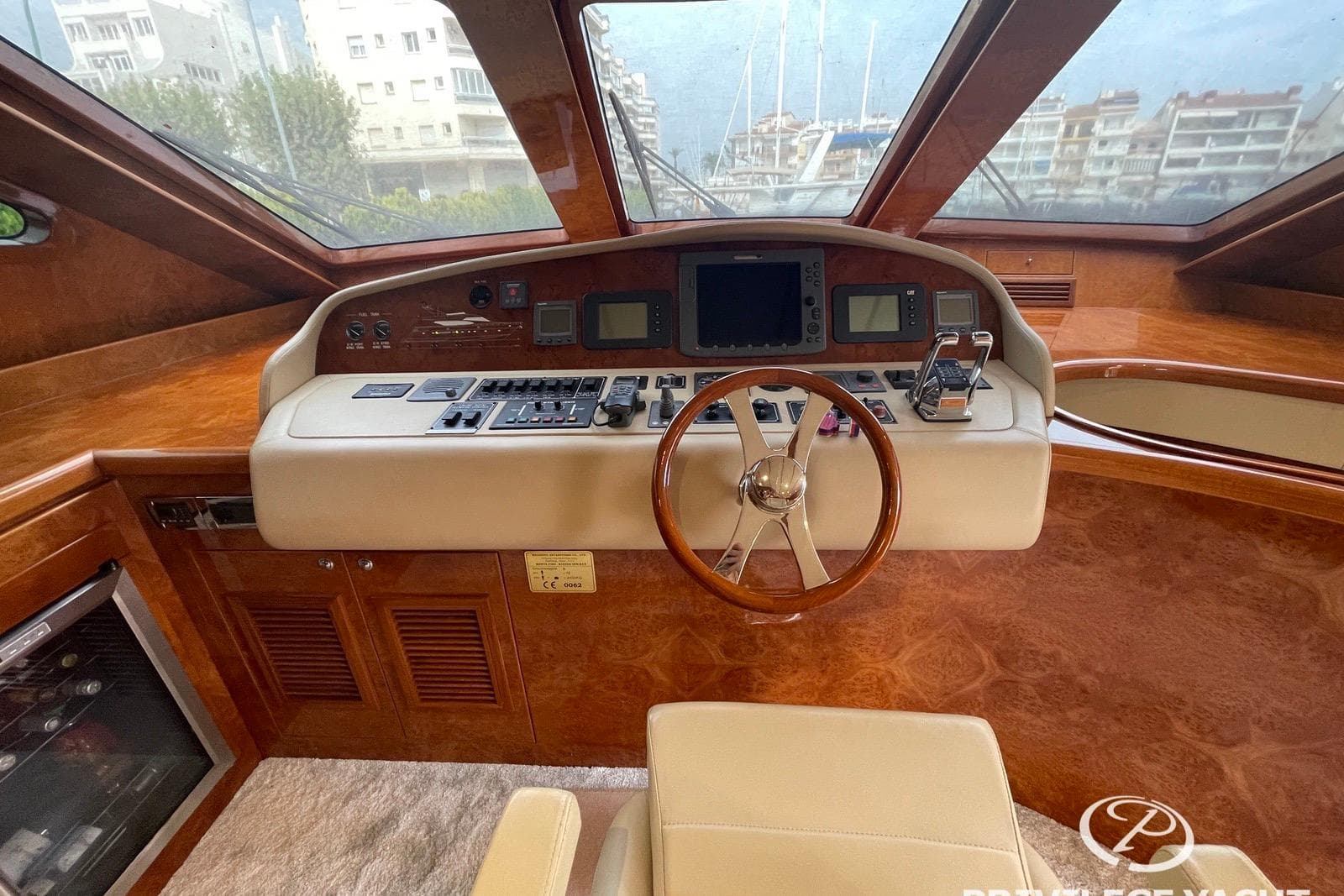 Luxurious 2006 Monte Fino 76 yacht helm with wood finish and modern controls.