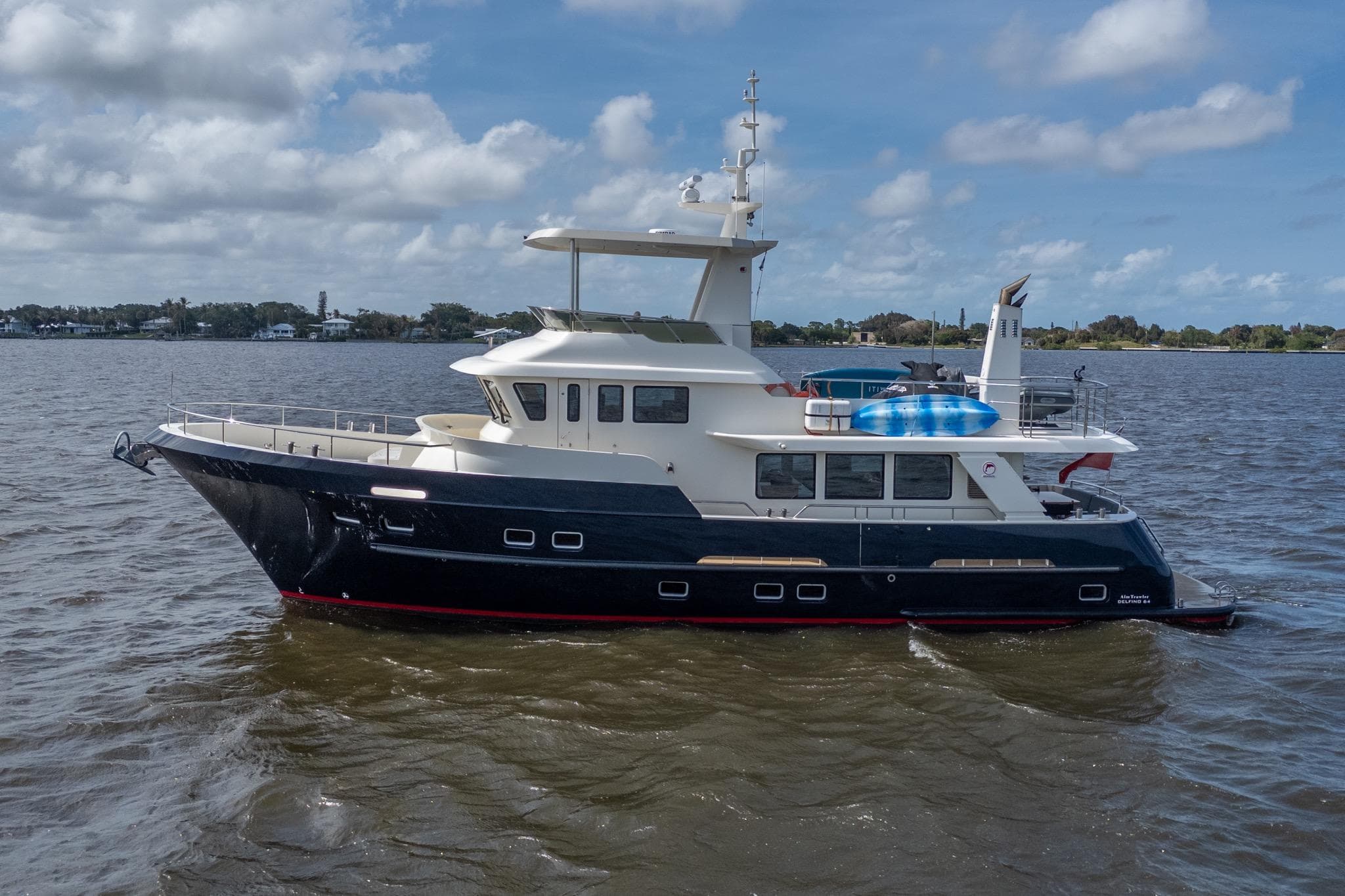 2022 Alm Trawler Delfino 64 by Jachtbouw De Alm cruising on a calm, scenic waterway.