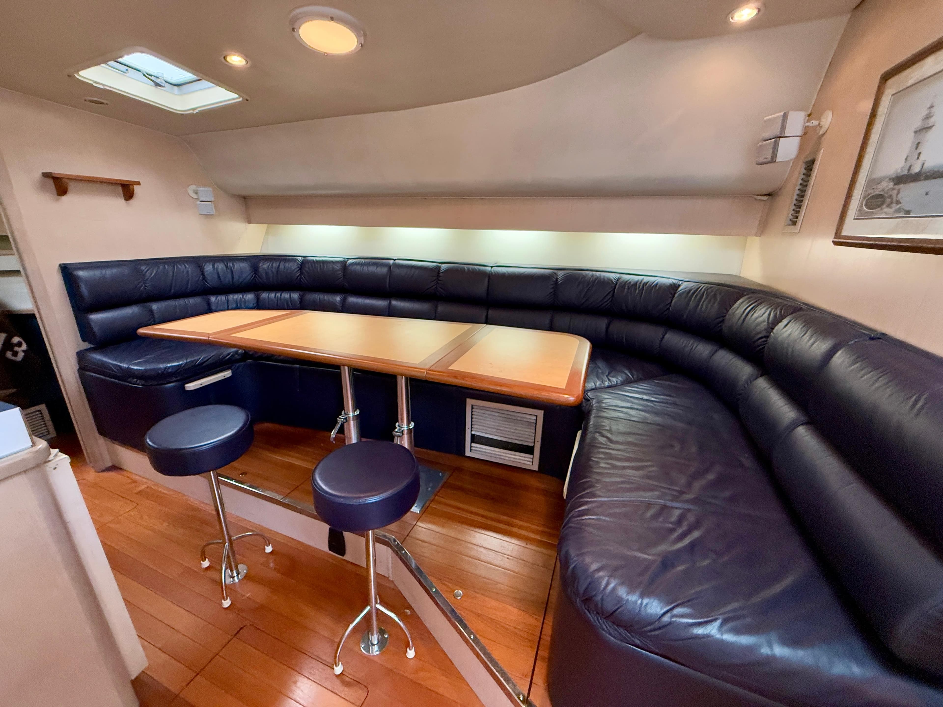 2004 Tiara Yachts 4000 Express interior with leather seating and wooden table.