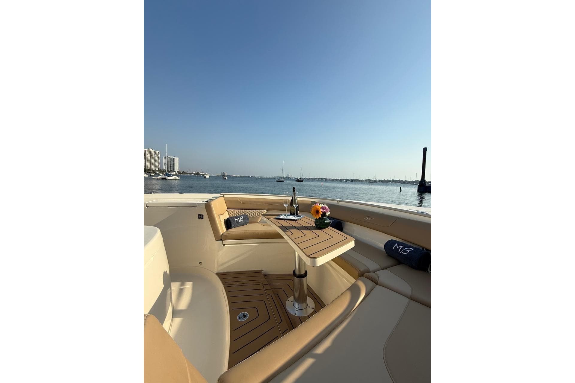 Luxurious 2024 Scout 400 LXF boat interior with elegant seating and scenic waterfront view.