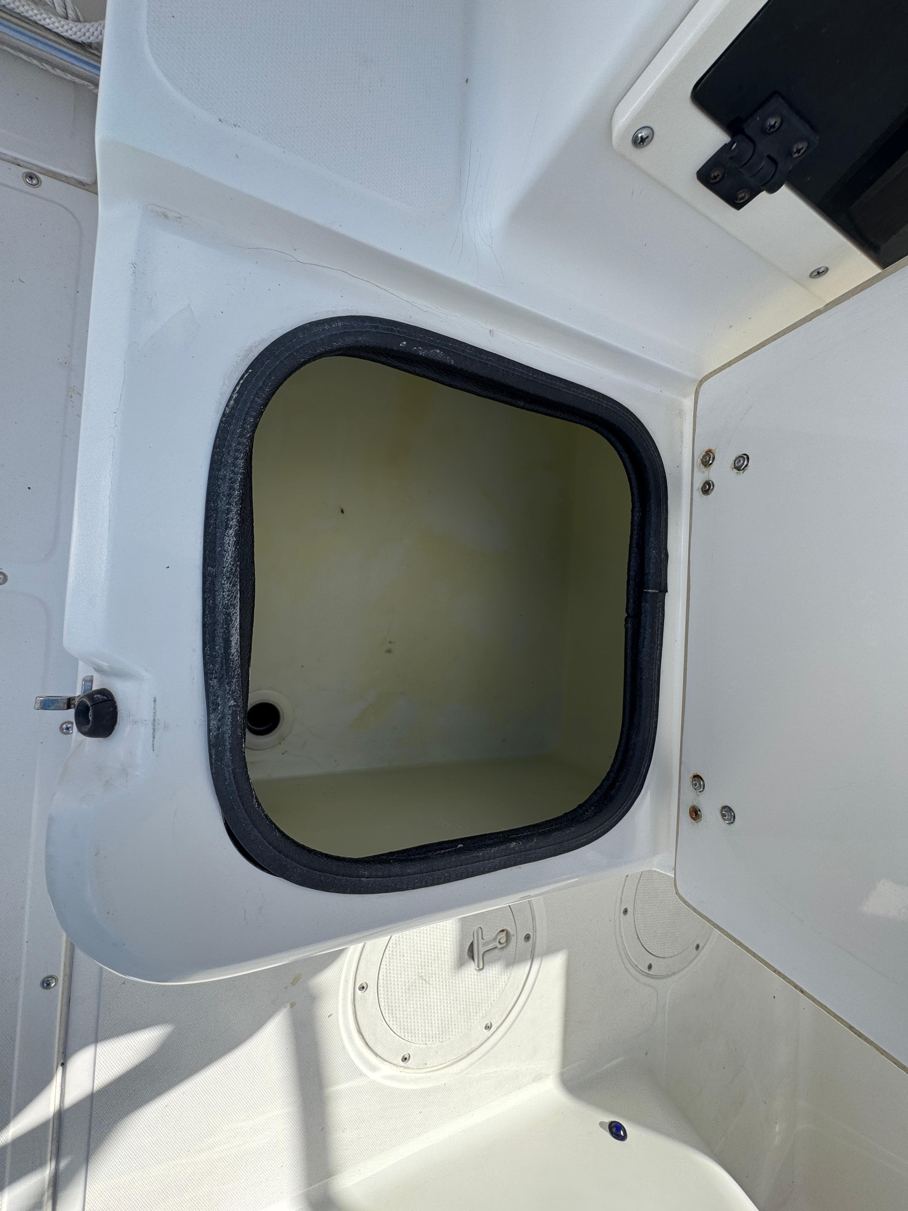 Open storage compartment on a 1999 Boston Whaler Conquest 23 boat.