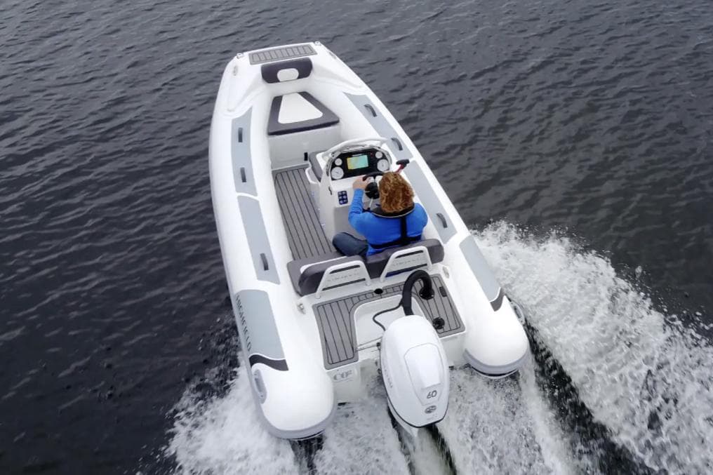 Manufacturer Provided Image: 2025 Highfield Sport 390 boat cruising on water, rear view.