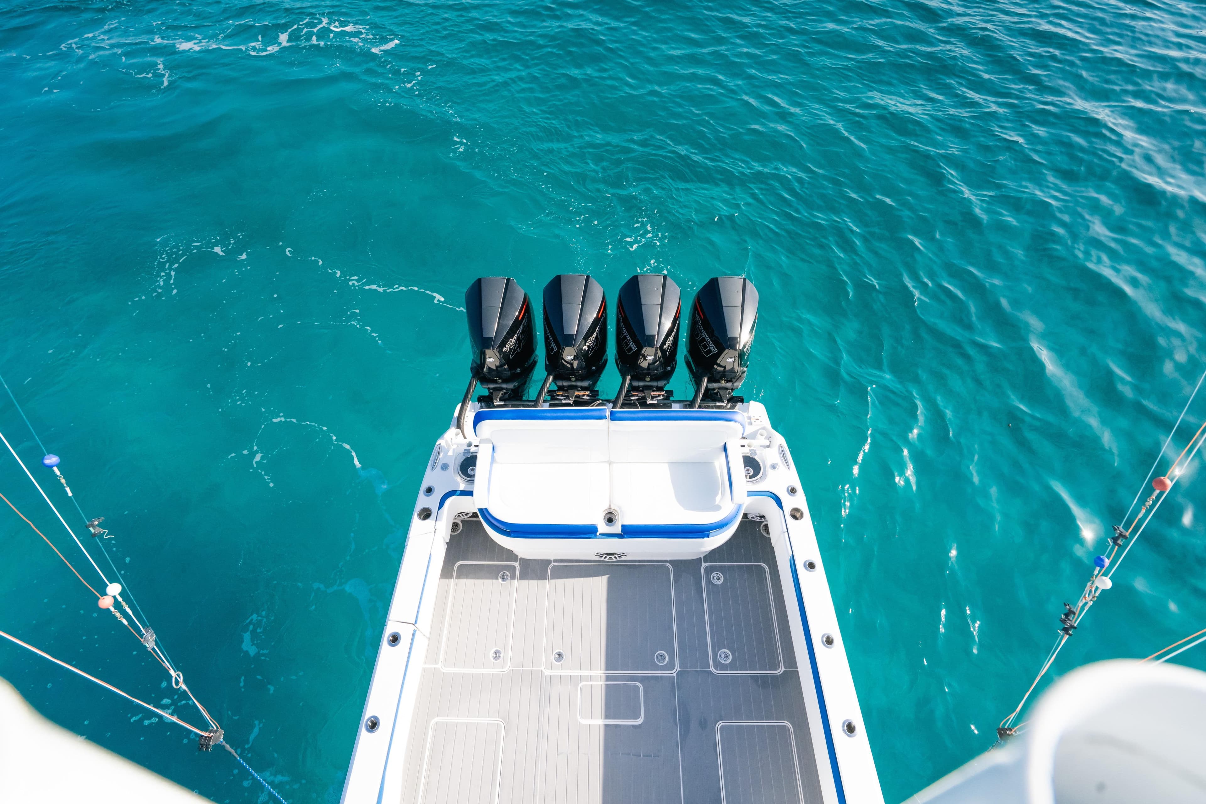 2022 Nor-Tech 392 Super Fish boat with four engines on turquoise water.