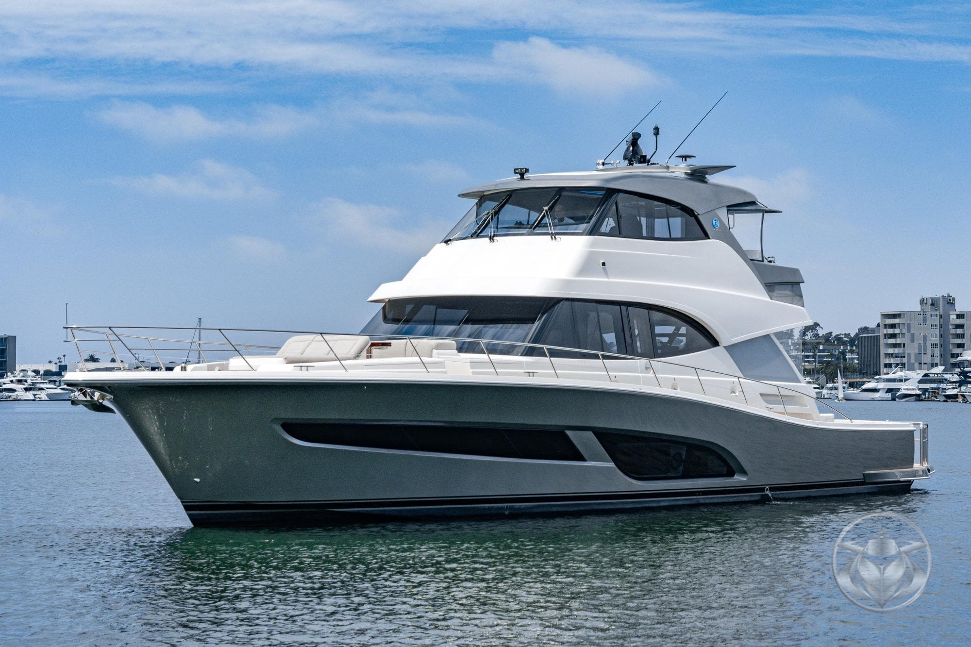2025 Riviera 64 Sports Motor Yacht on calm water, showcasing sleek design and luxury features.
