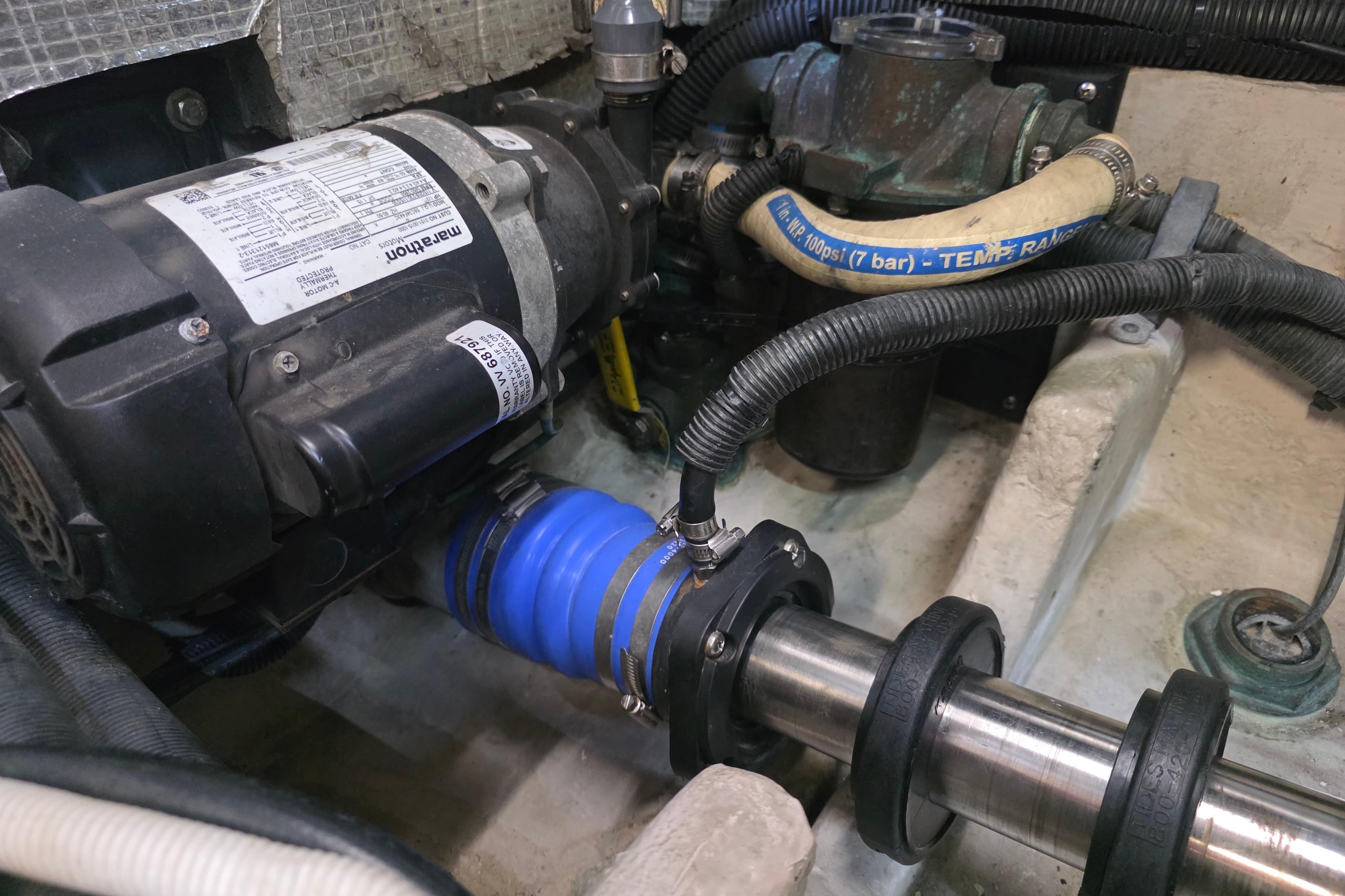 Engine compartment of a 2002 Sea Ray 560 Sedan Bridge, featuring mechanical components and hoses.