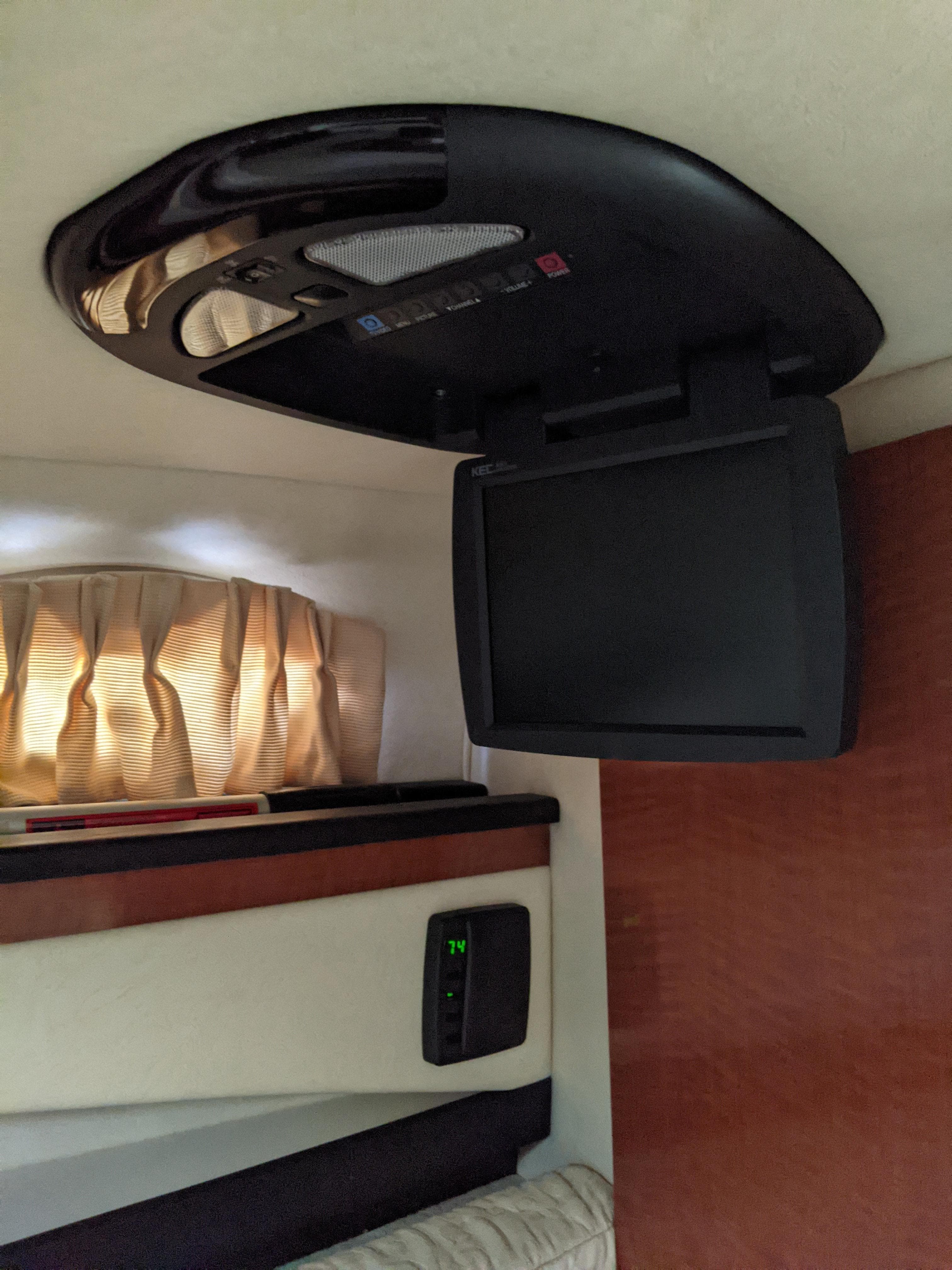 Interior of a 2005 Sea Ray 260 Sundancer with ceiling-mounted TV.