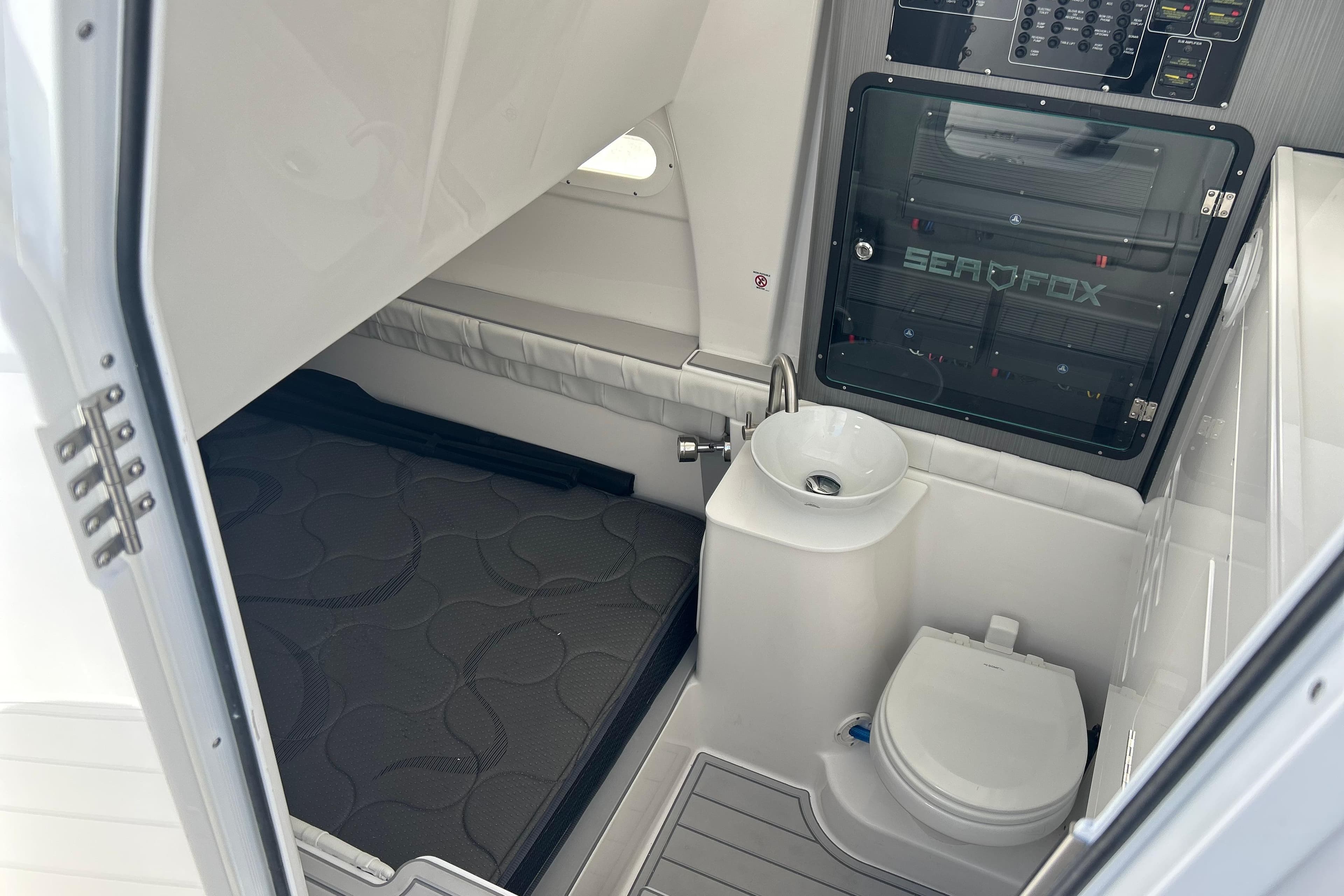 Interior of 2026 Sea Fox 368 Commander boat with compact bathroom and sleeping area.