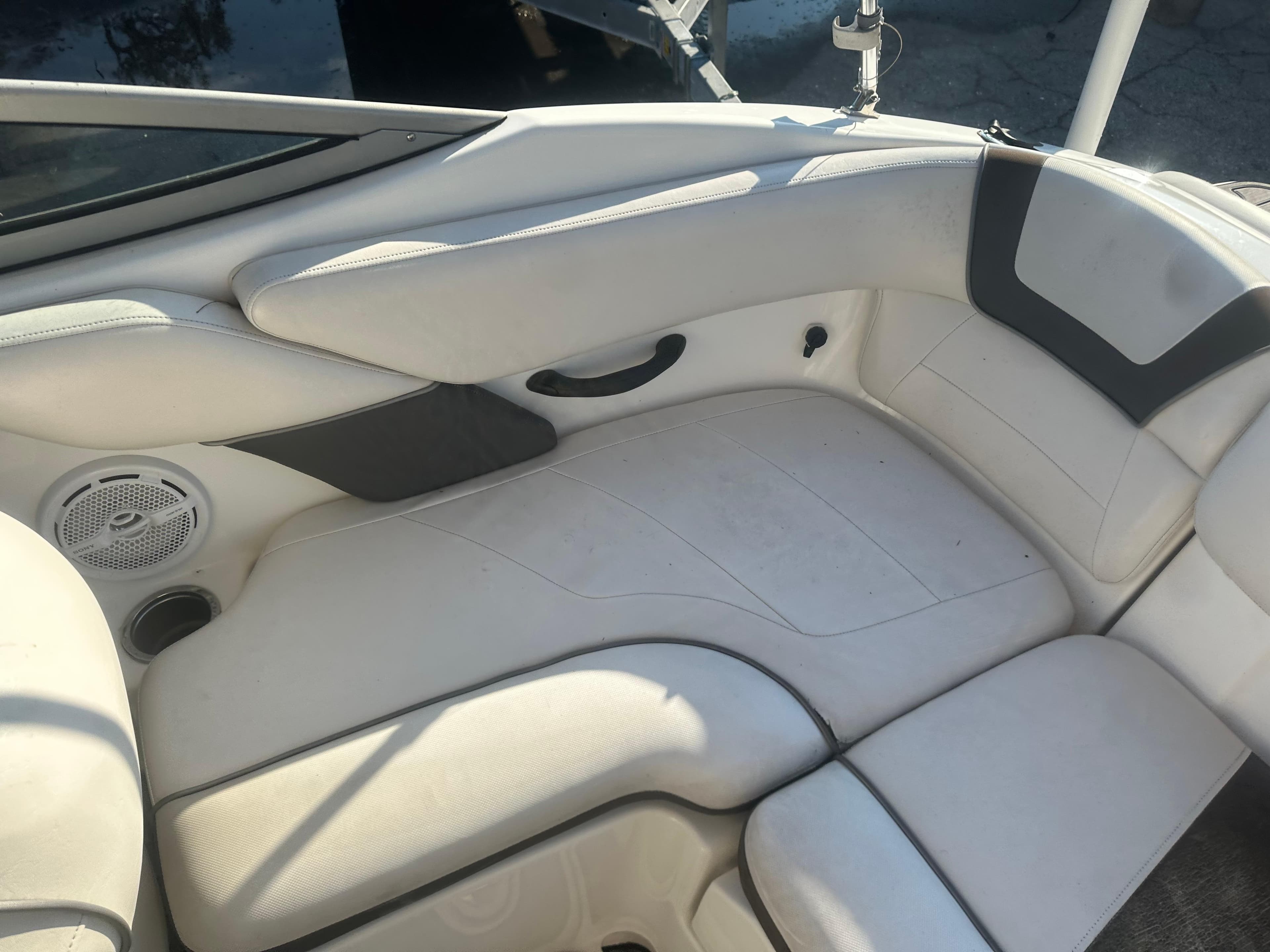 2013 Yamaha Boats SX192 interior seating with white upholstery and speaker.