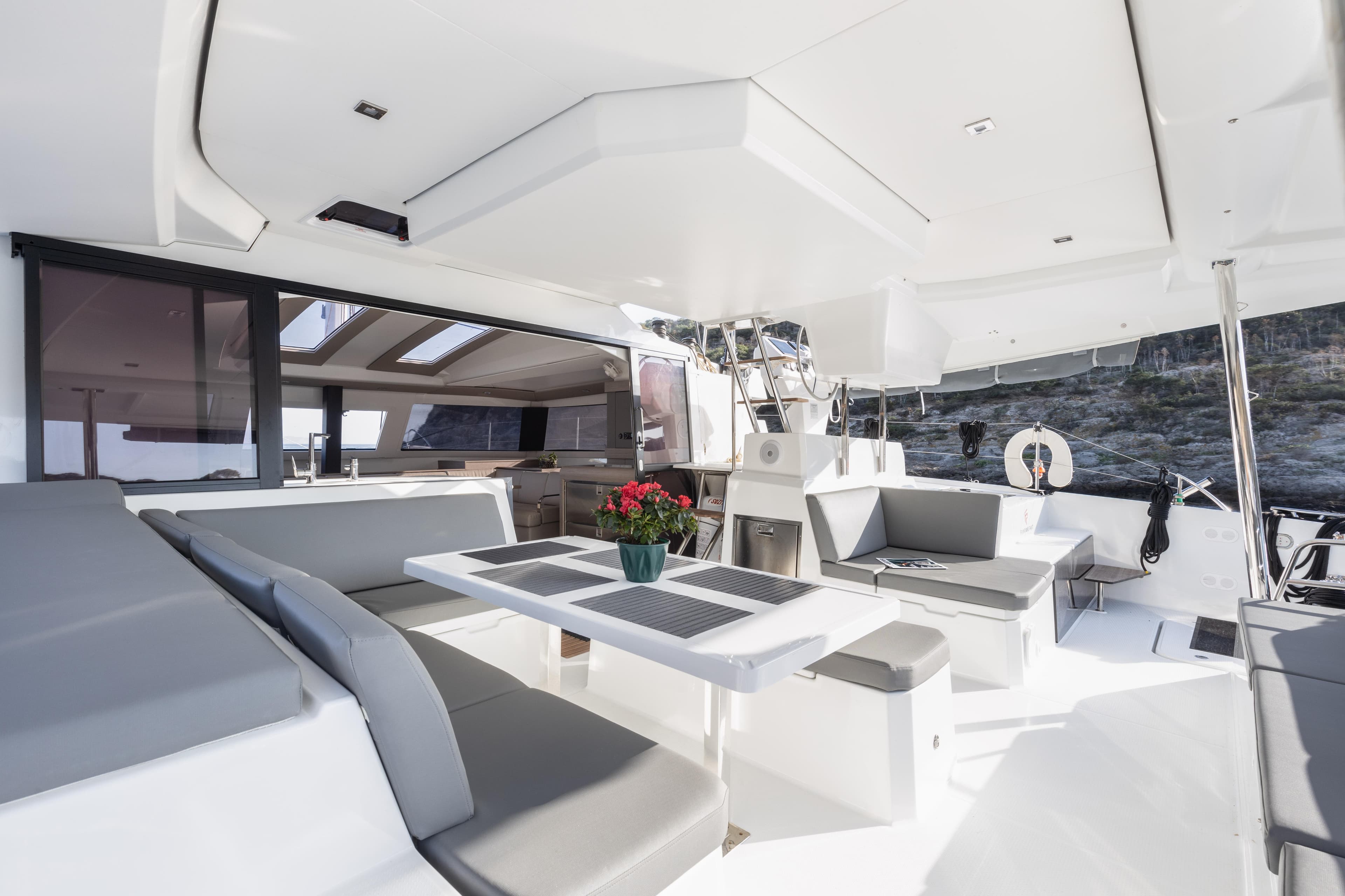 2023 Fountaine Pajot Catamaran Elba 45 interior with modern seating and dining area.