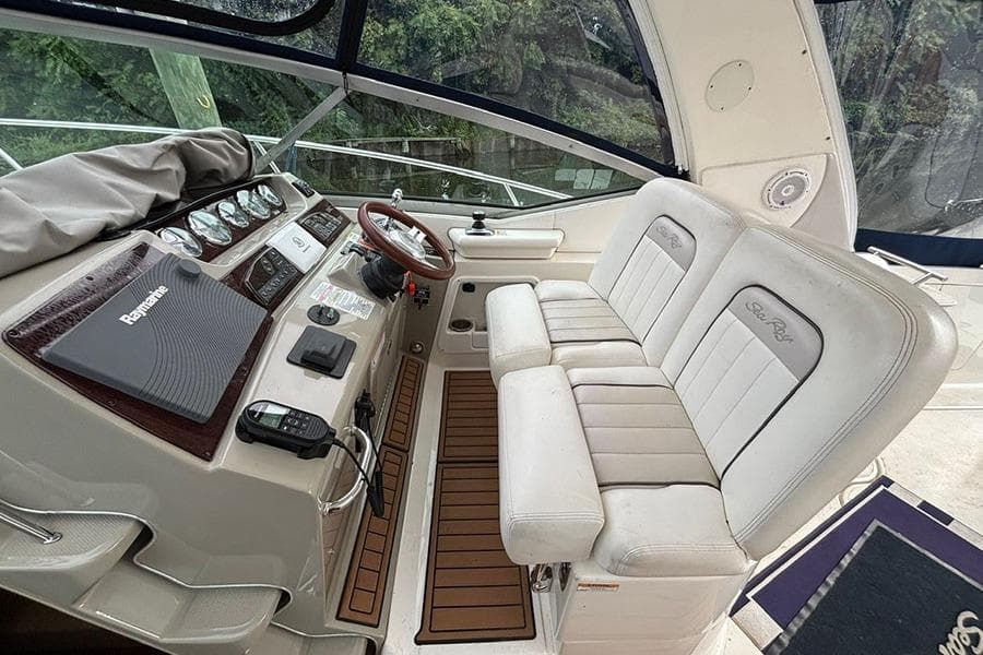Interior of a 2011 Sea Ray 370 Sundancer boat with helm and seating area.