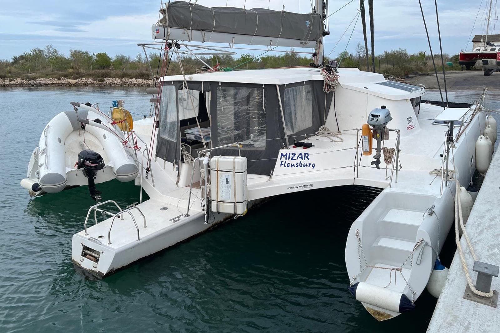 2019 Neel Trimaran NEEL 45 EVOLUTION docked with inflatable dinghy attached.