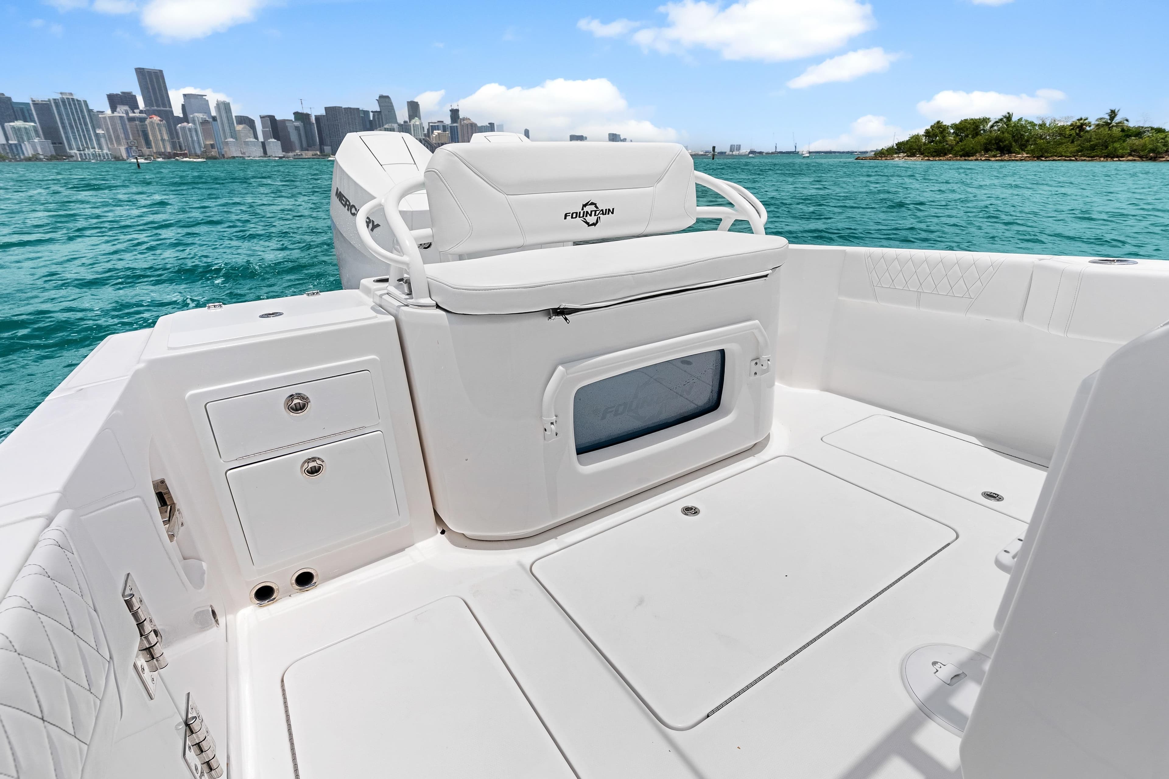 2025 Fountain 32 NX boat interior with seating, storage, and ocean view.