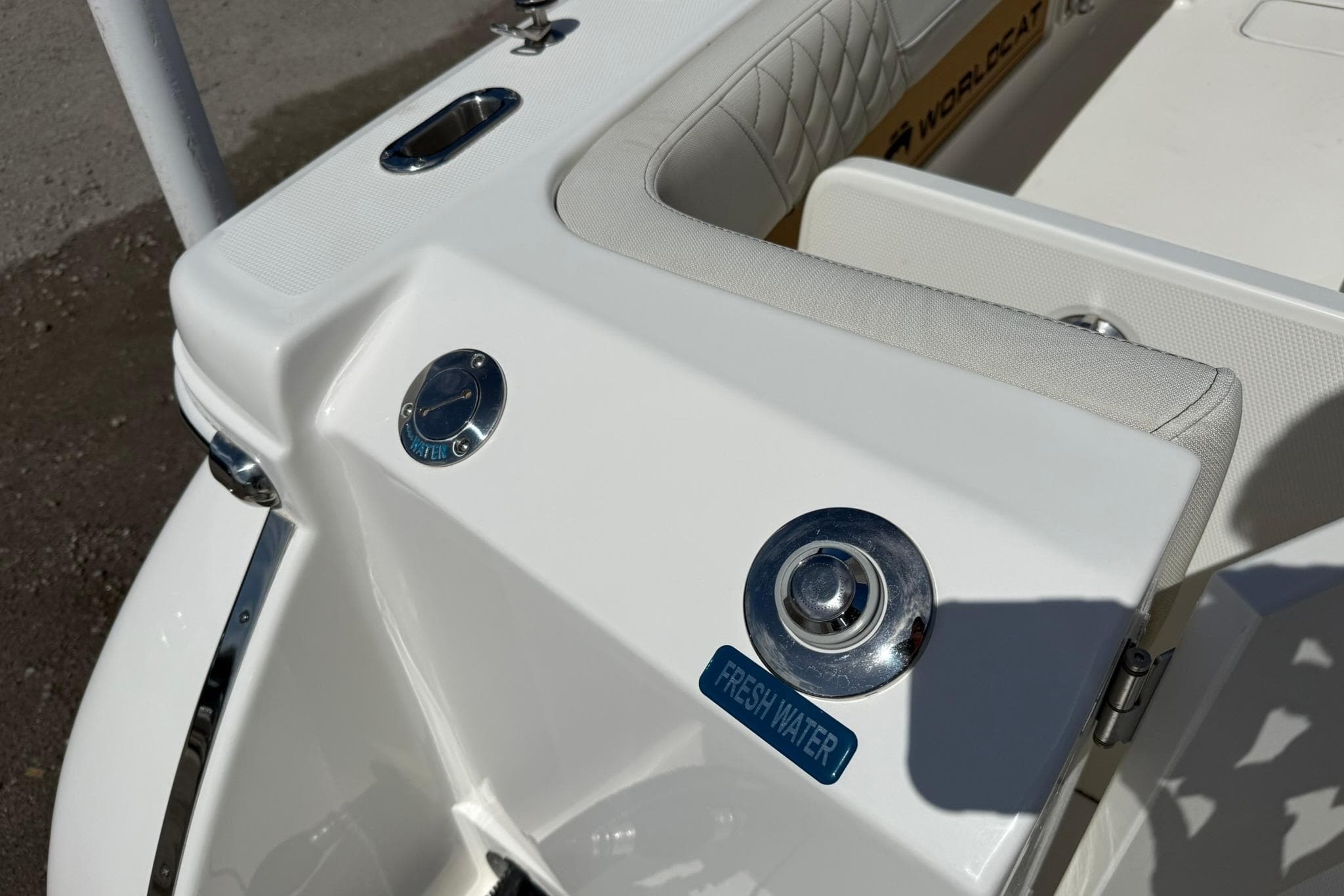 2026 World Cat 280 CC-X boat detail showing fresh water access and seating.