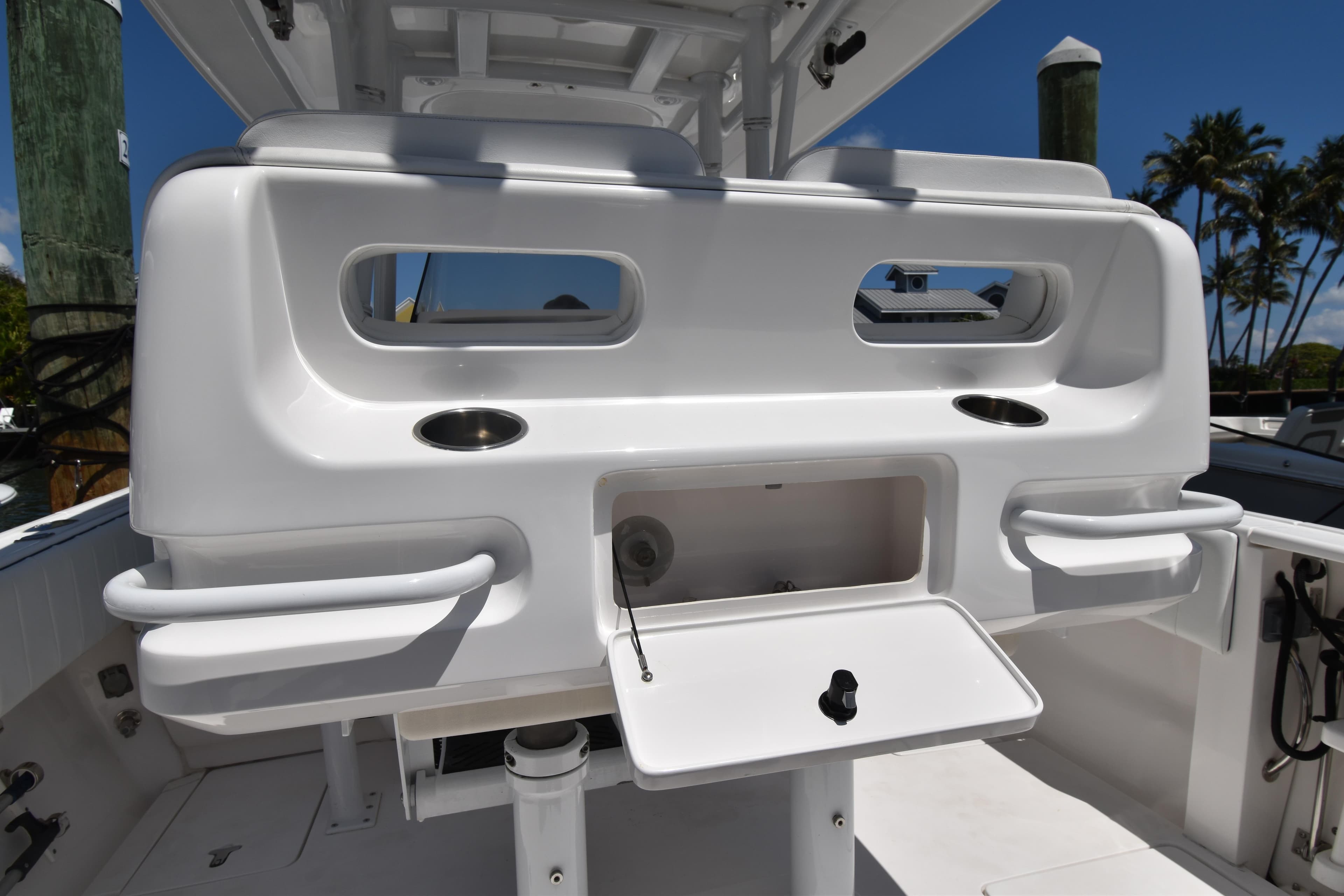 2013 Intrepid 327 Cuddy boat interior with storage compartment and cup holders.