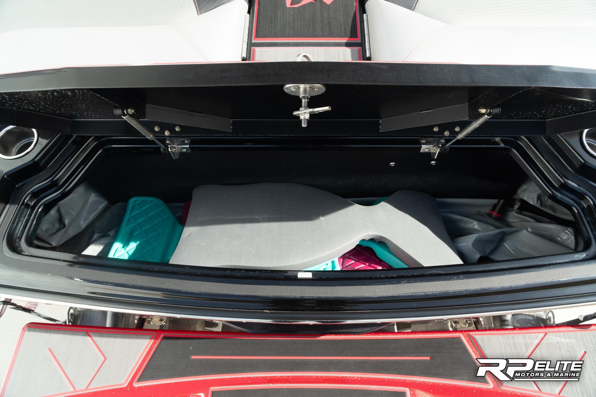 2024 Centurion Ri245 boat storage compartment with colorful interior padding.