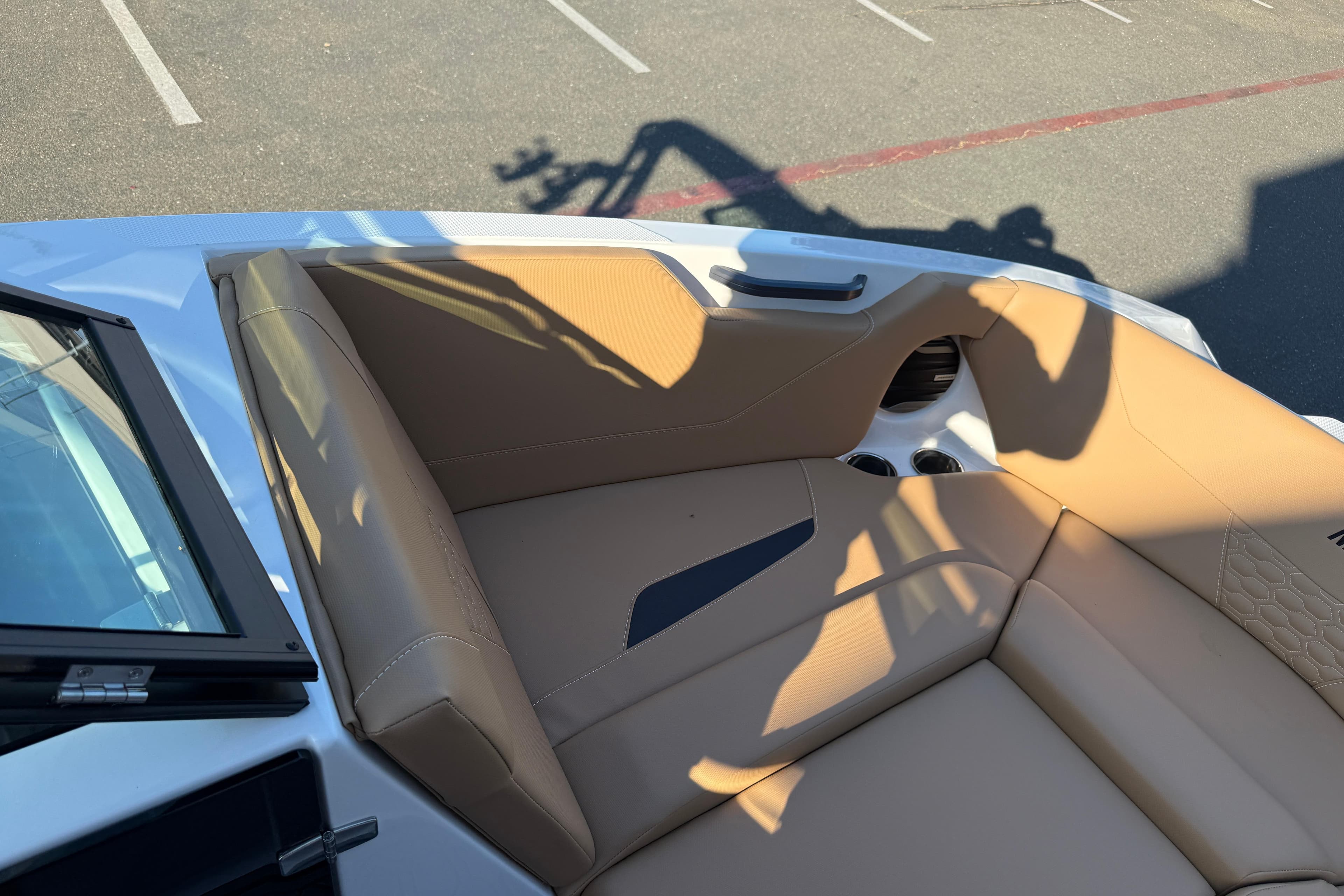2026 MasterCraft NXT22 boat interior with tan seating and cup holders.