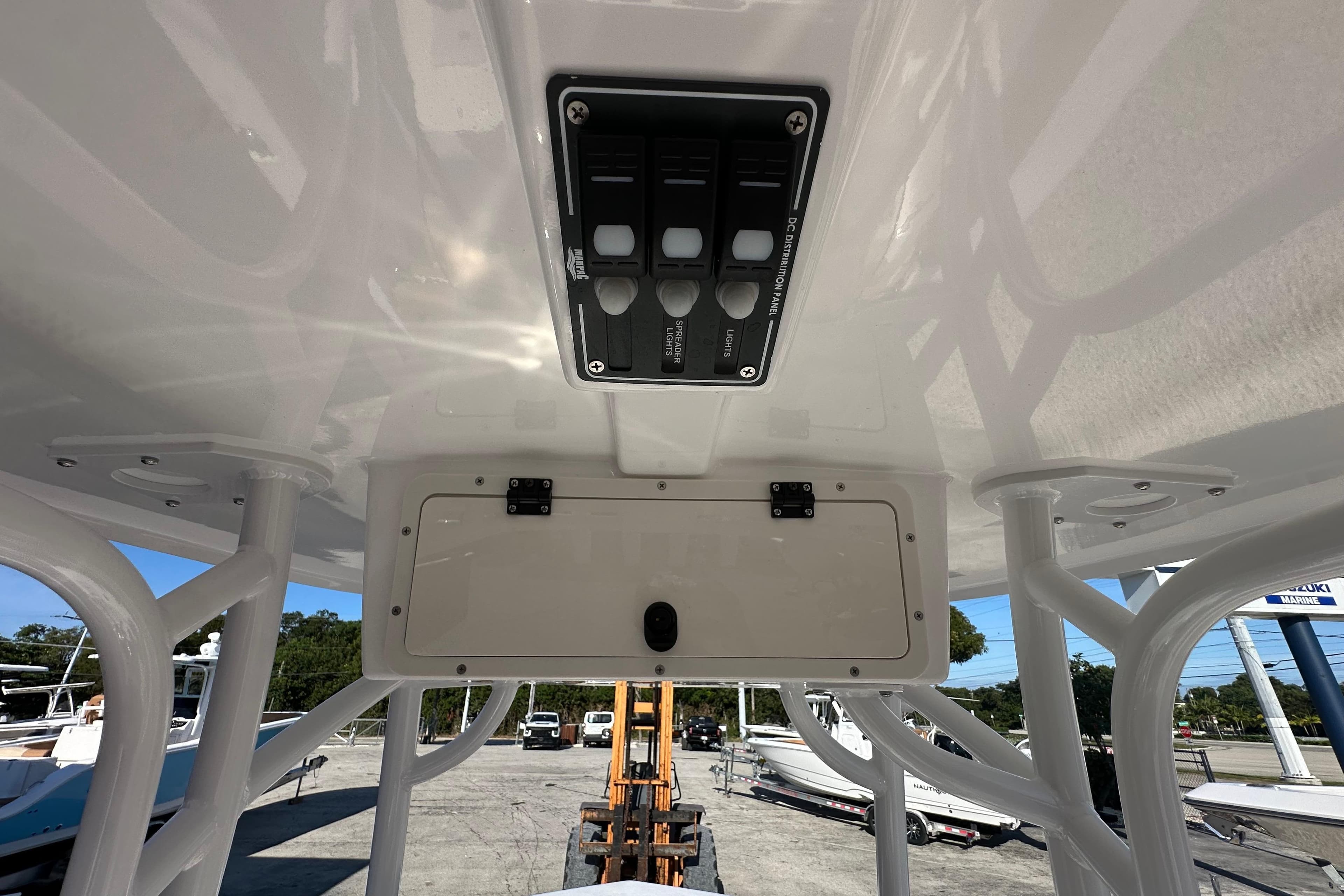 2025 NauticStar 231 Hybrid boat console with control panel and storage compartment.