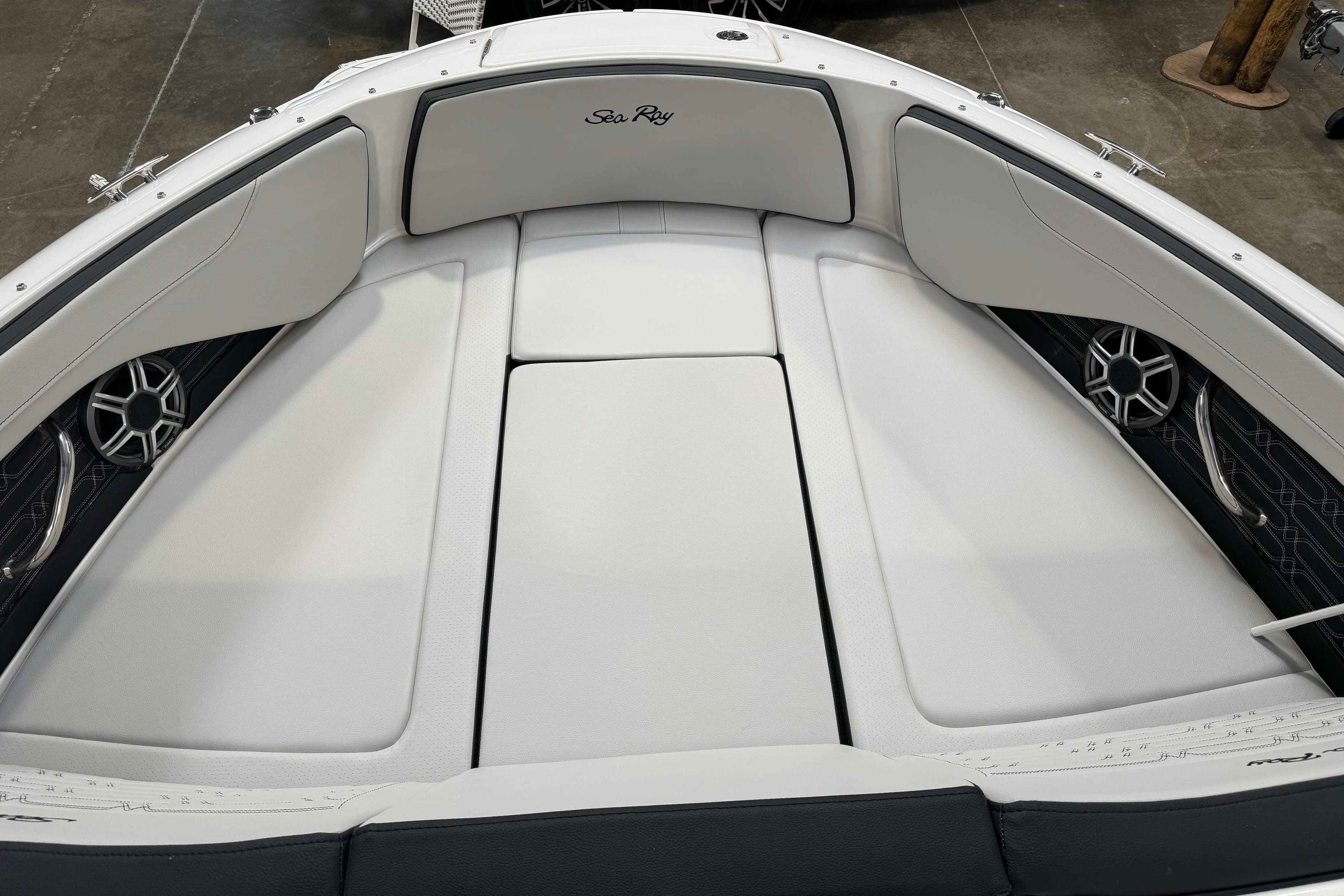 2026 Sea Ray SPX 210 boat interior with white cushioned seating and built-in speakers.