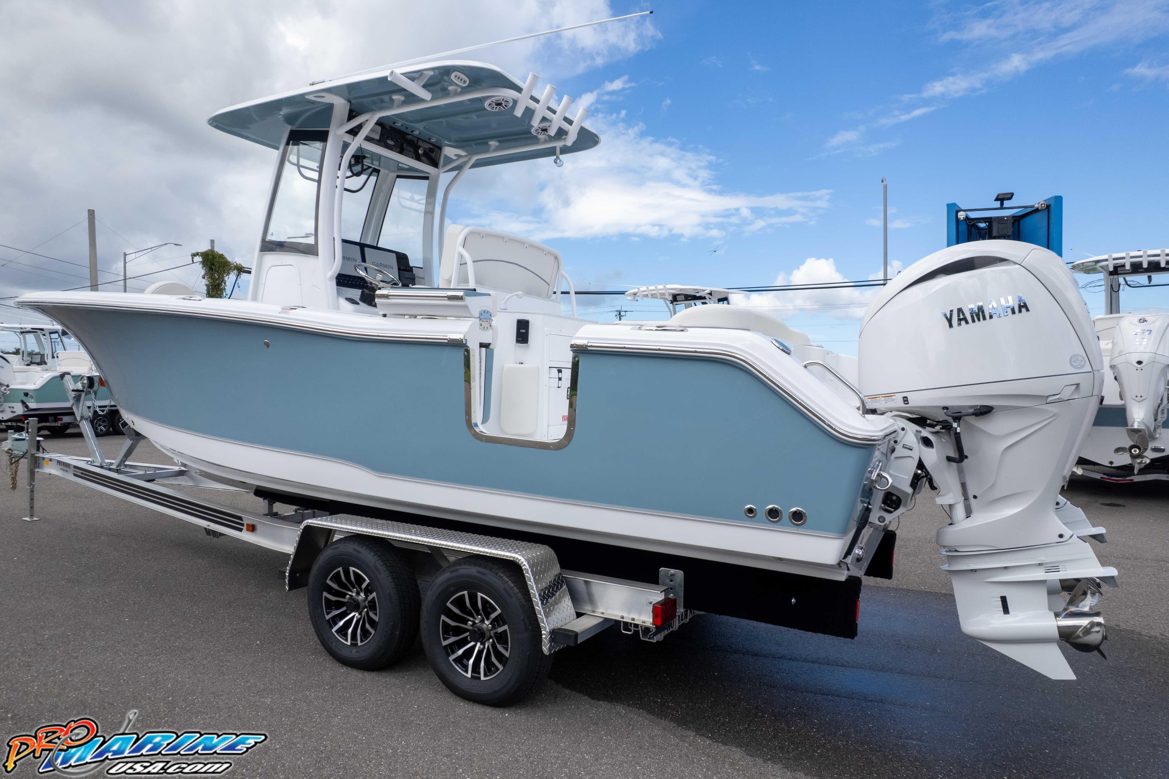 2026 Sea Hunt Ultra 265 SE boat on trailer with Yamaha engine, side view.