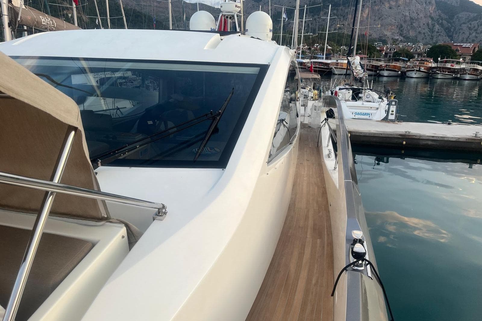 2014 Numarine 70 yacht docked in a scenic marina with clear waters.