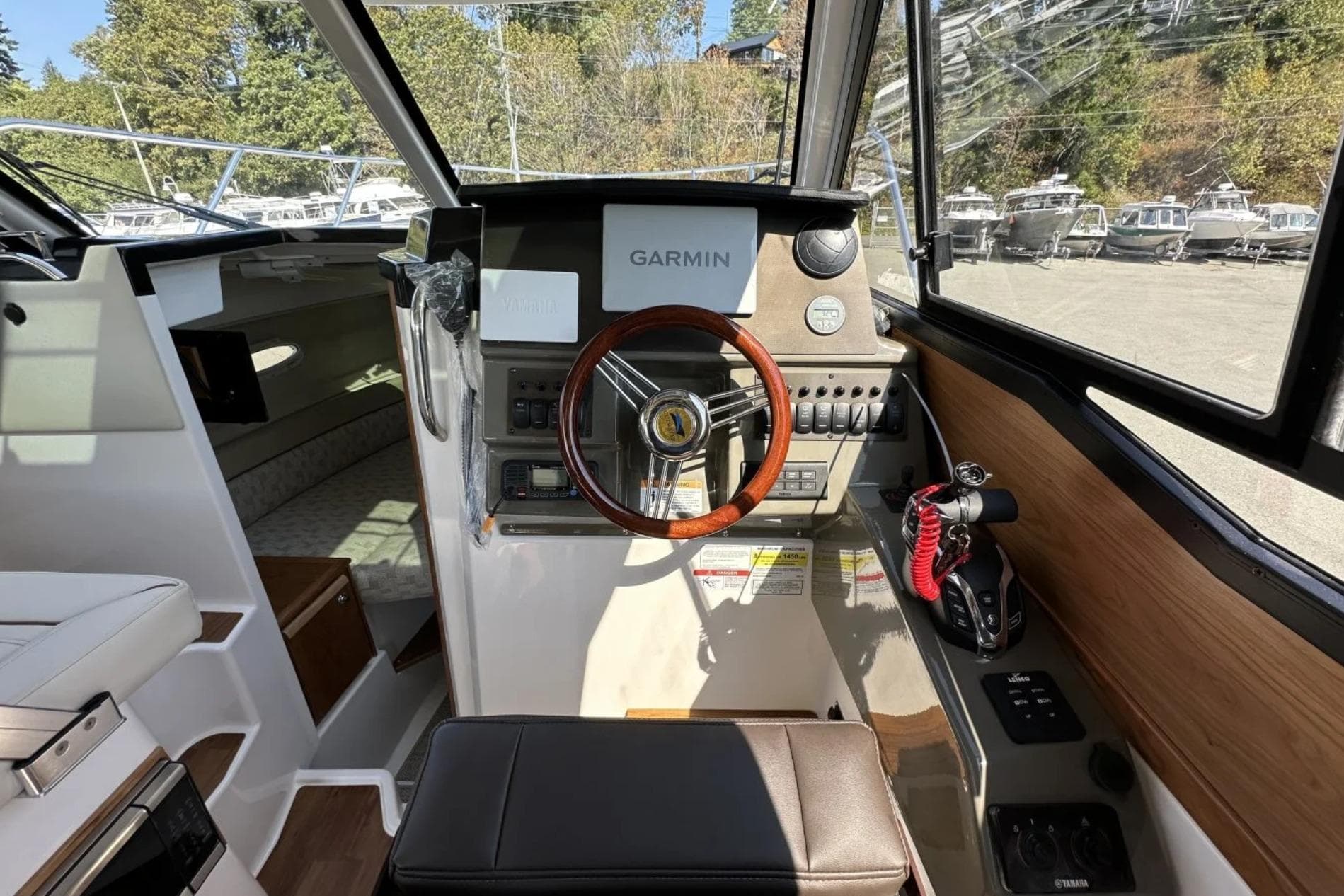 2026 Cutwater C-248 Coupe helm with Garmin navigation, featuring modern controls and wood accents.