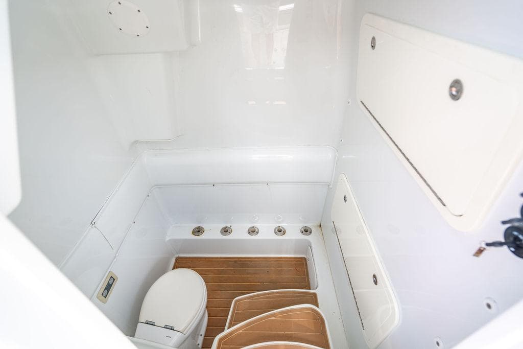 2015 Yellowfin CC boat interior with toilet and wooden flooring.