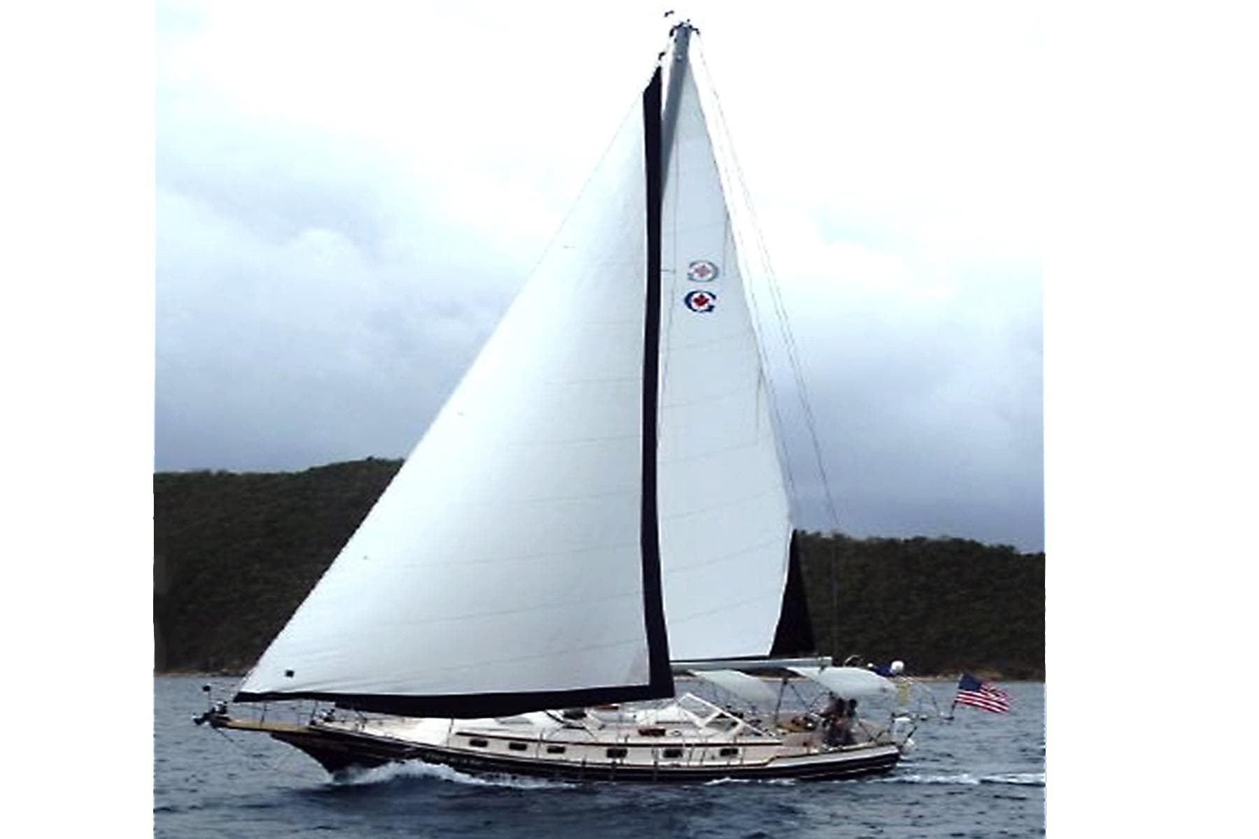 Sailing yacht Gozzard 41B, 2008 model, cruising on open water with full sails.