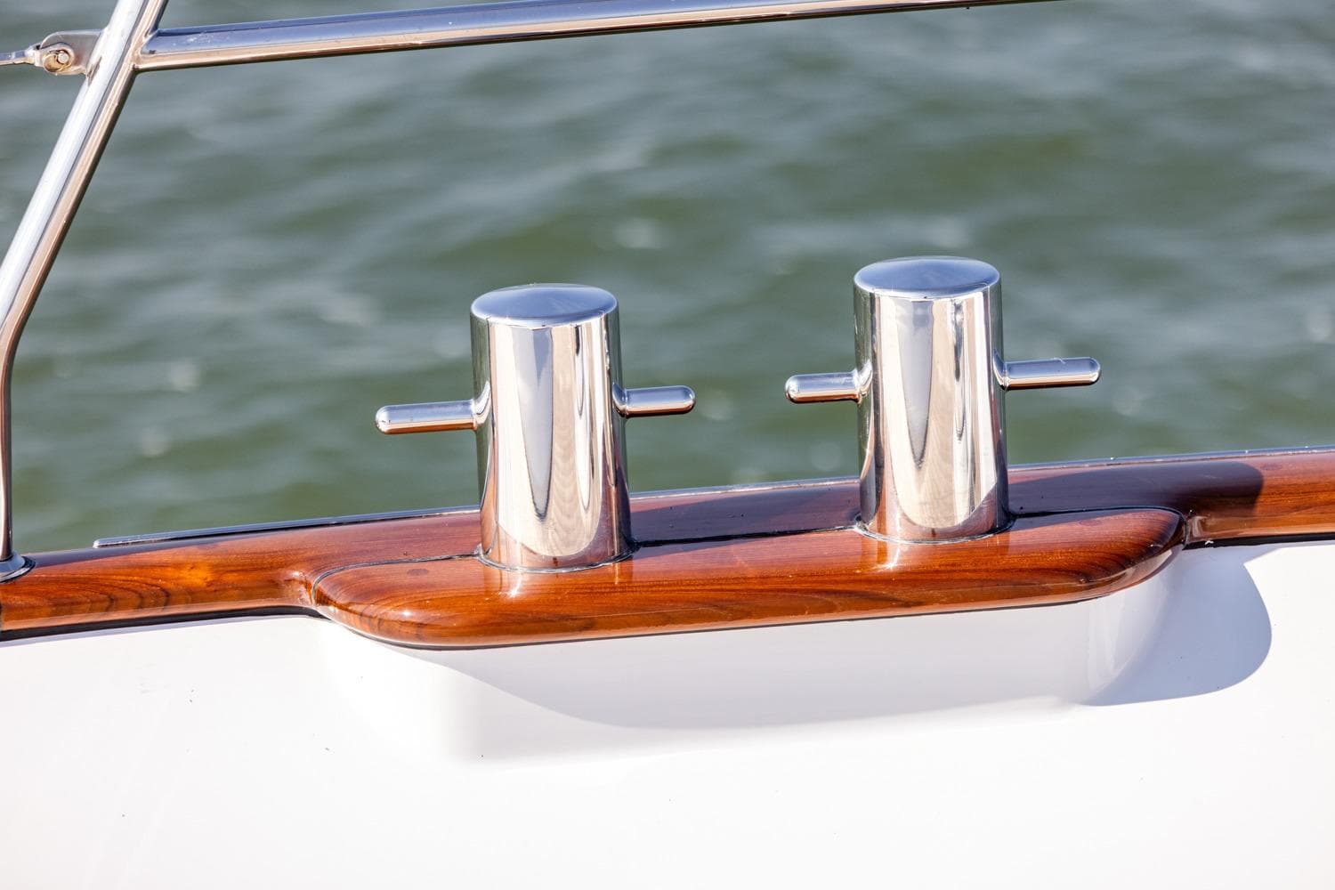 Polished cleats on Mulder 70 Wheelhouse CLASY yacht, 2009 model, with wooden trim.