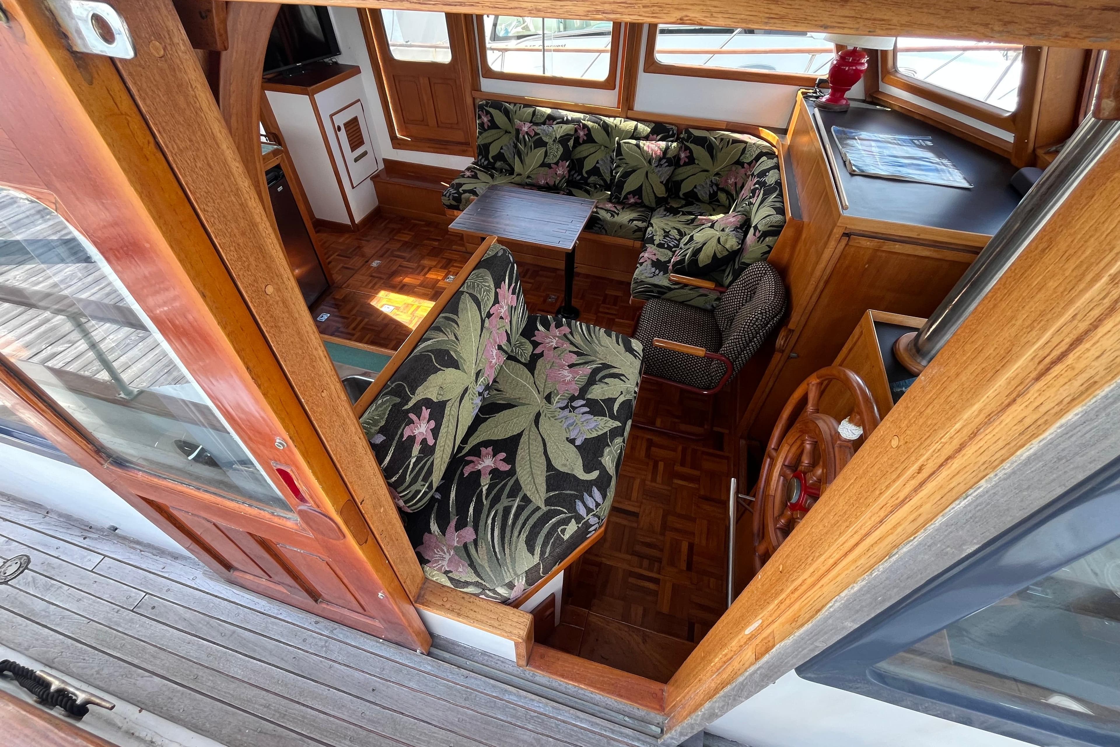 1978 Marine Trader 40 interior with floral upholstery and wooden accents.