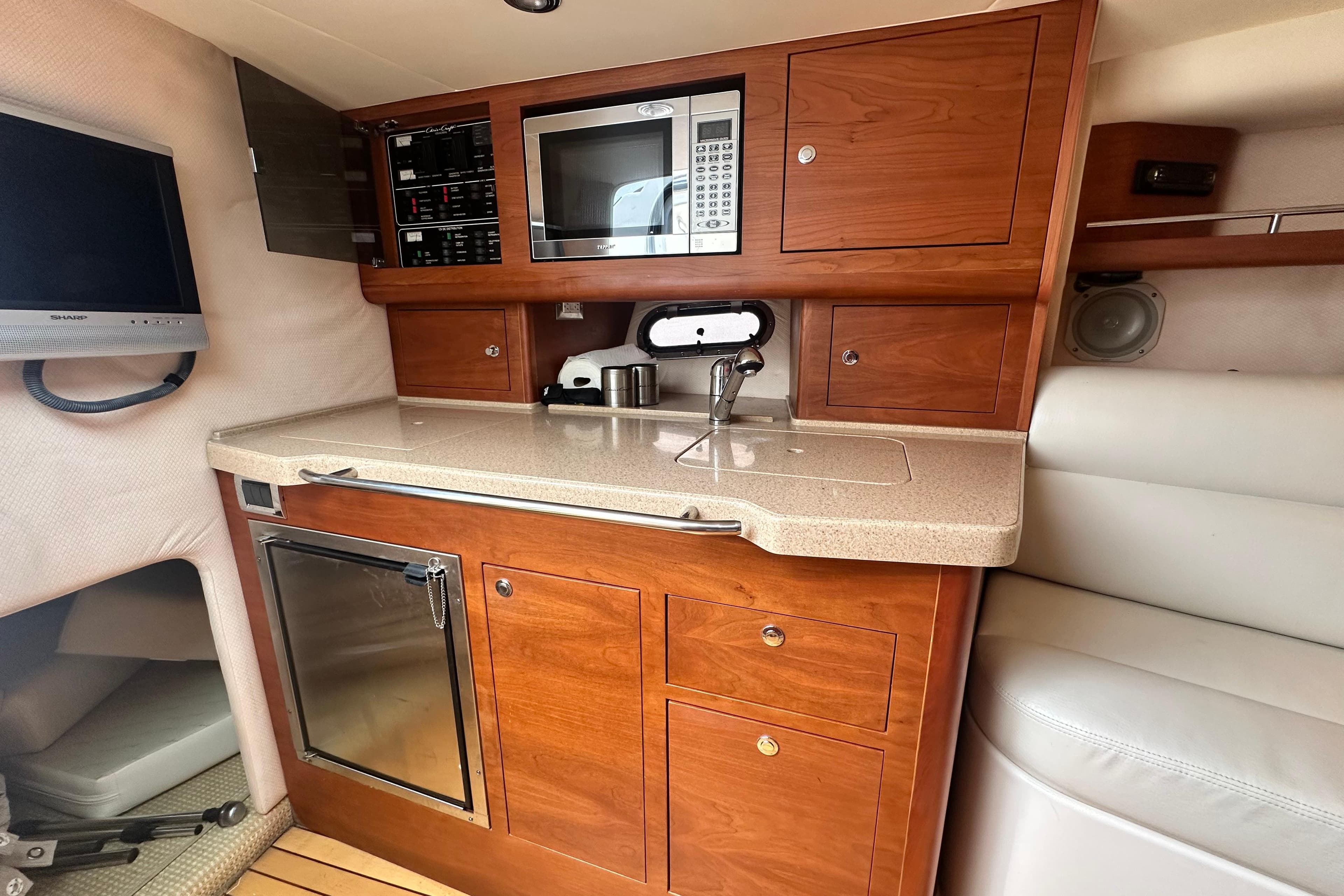 Luxurious 2007 Chris-Craft Corsair 33 Heritage Edition cabin with kitchenette and modern amenities.