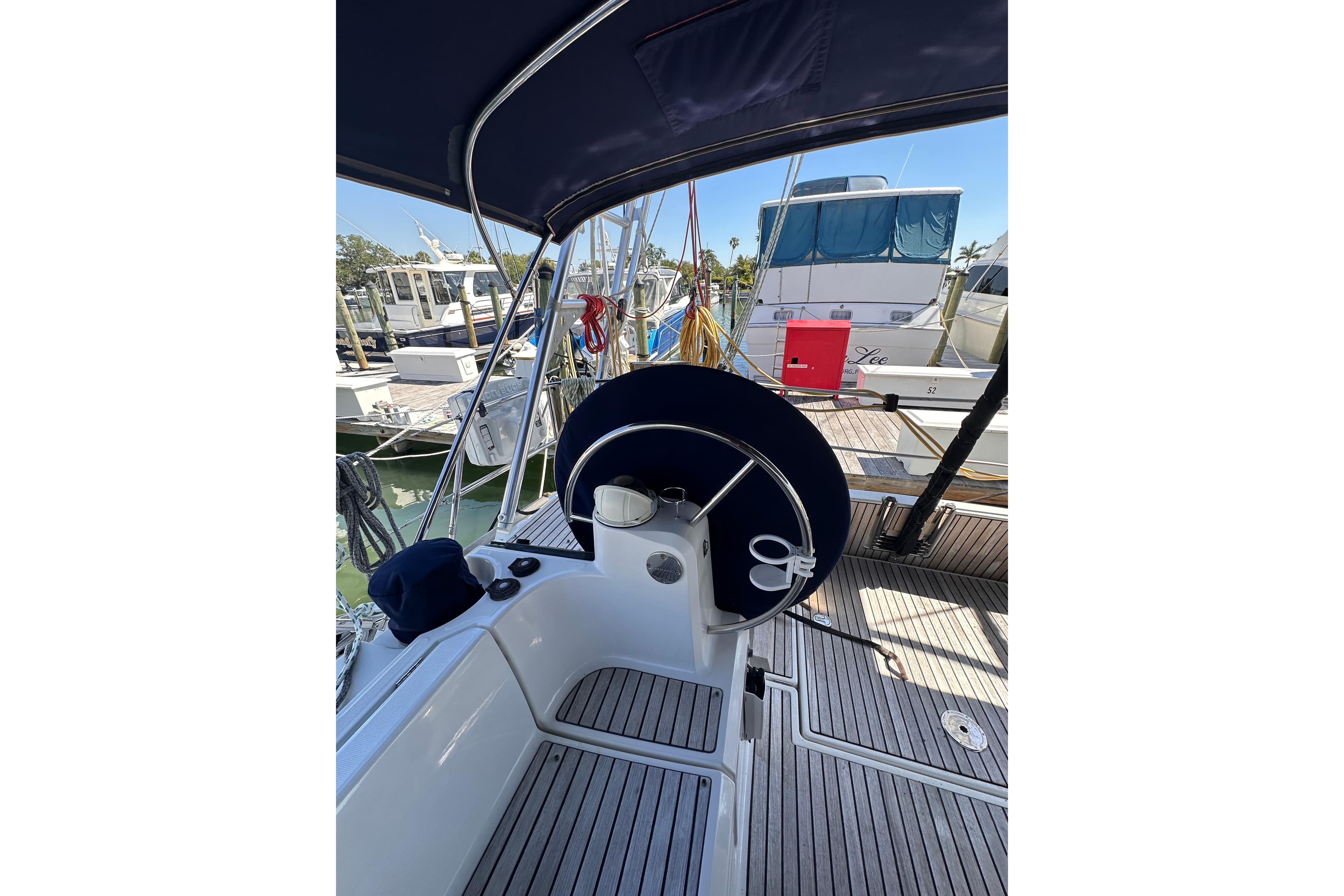 Cockpit view of 2015 Jeanneau Sun Odyssey 469 sailboat docked at marina.