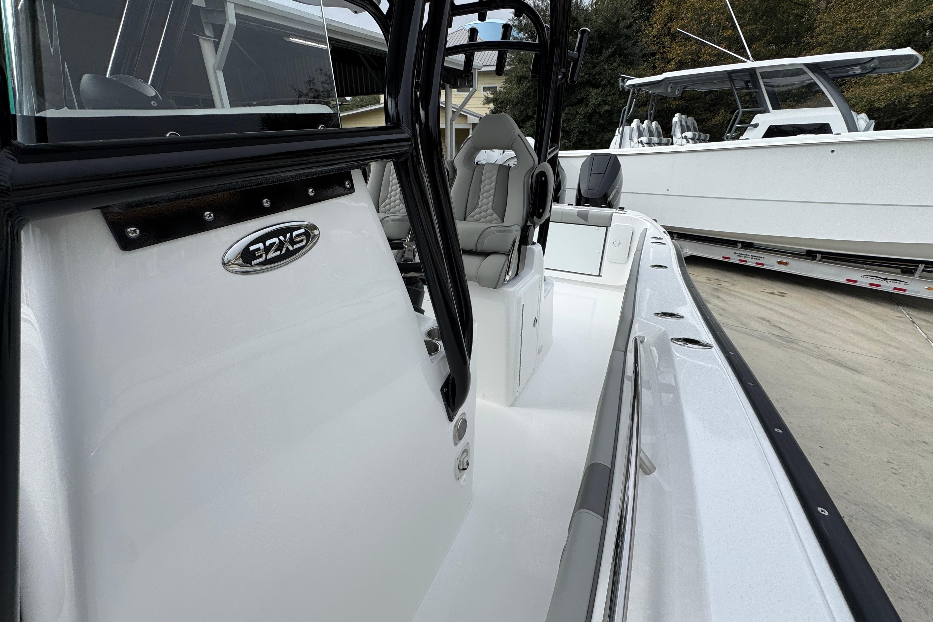 2026 Cape Horn 32 XS boat, sleek design, white exterior, modern seating, docked outdoors.