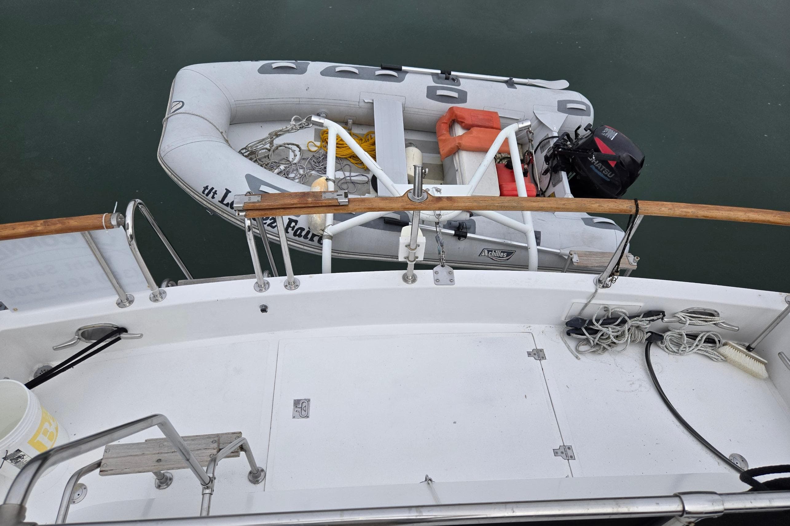 Ocean Alexander 423 Classicco 1993 yacht deck with dinghy and outboard motor.