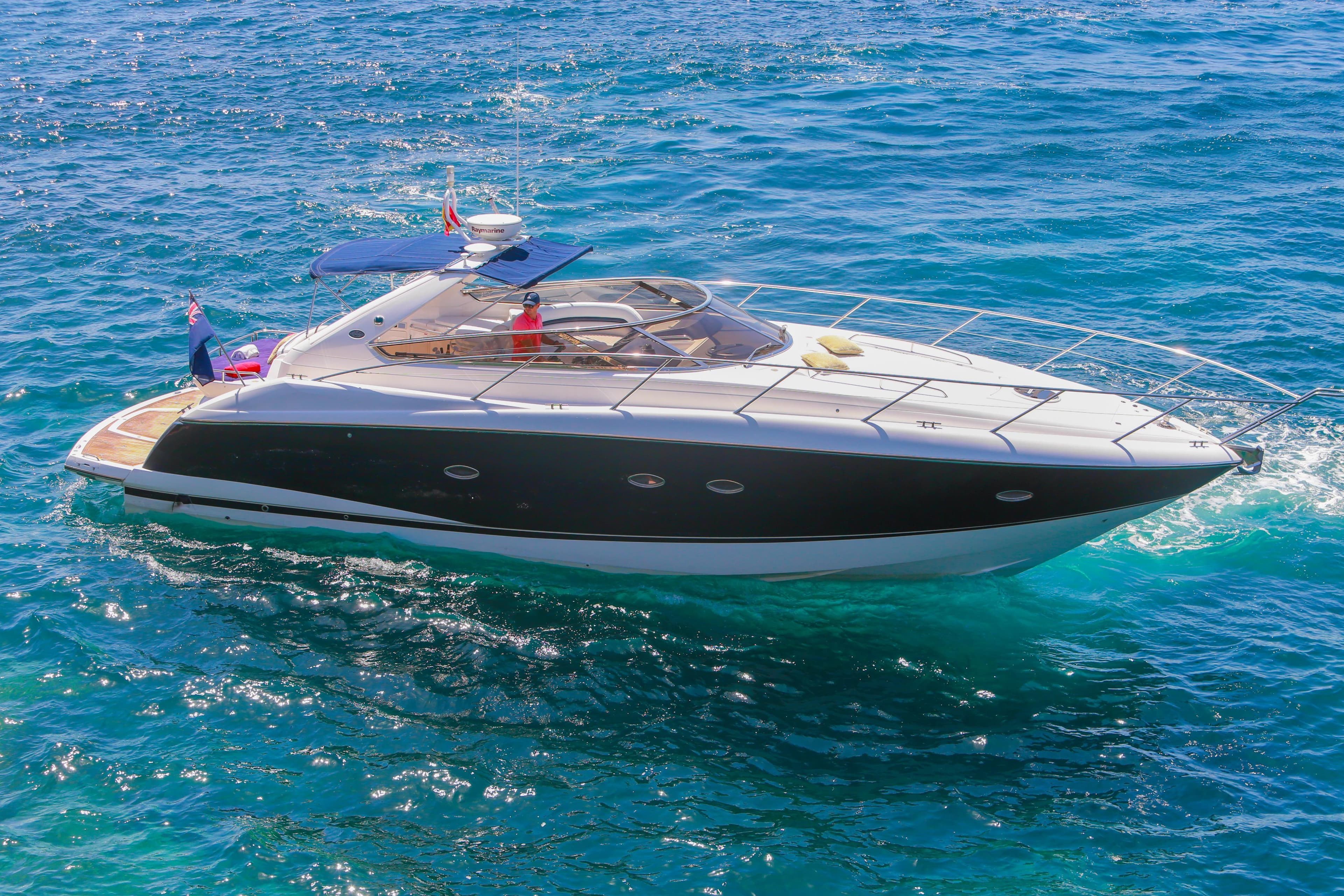 2007 Sunseeker Portofino 47 Open yacht cruising on clear blue water.