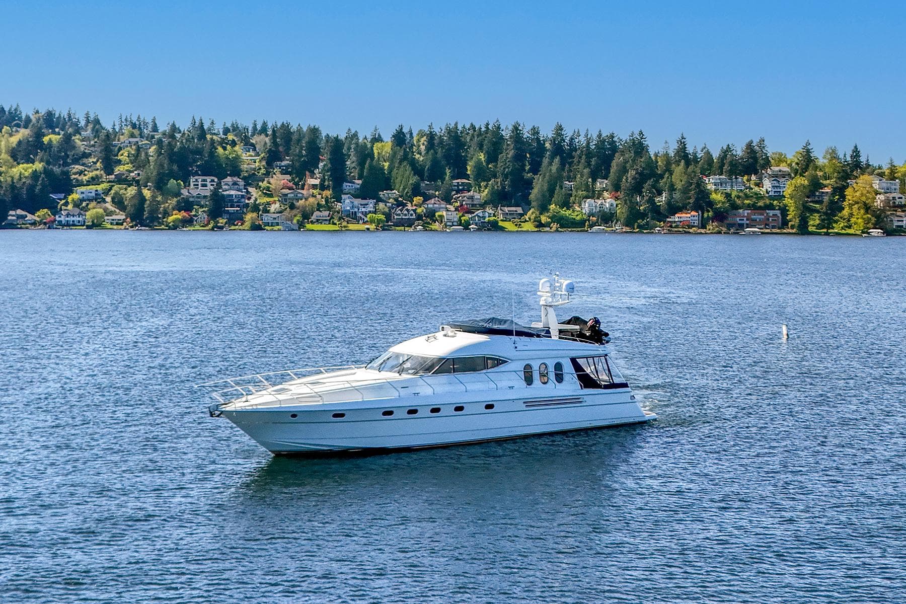 2001 Viking Sport Cruisers Motoryacht on scenic lake with forested shoreline.
