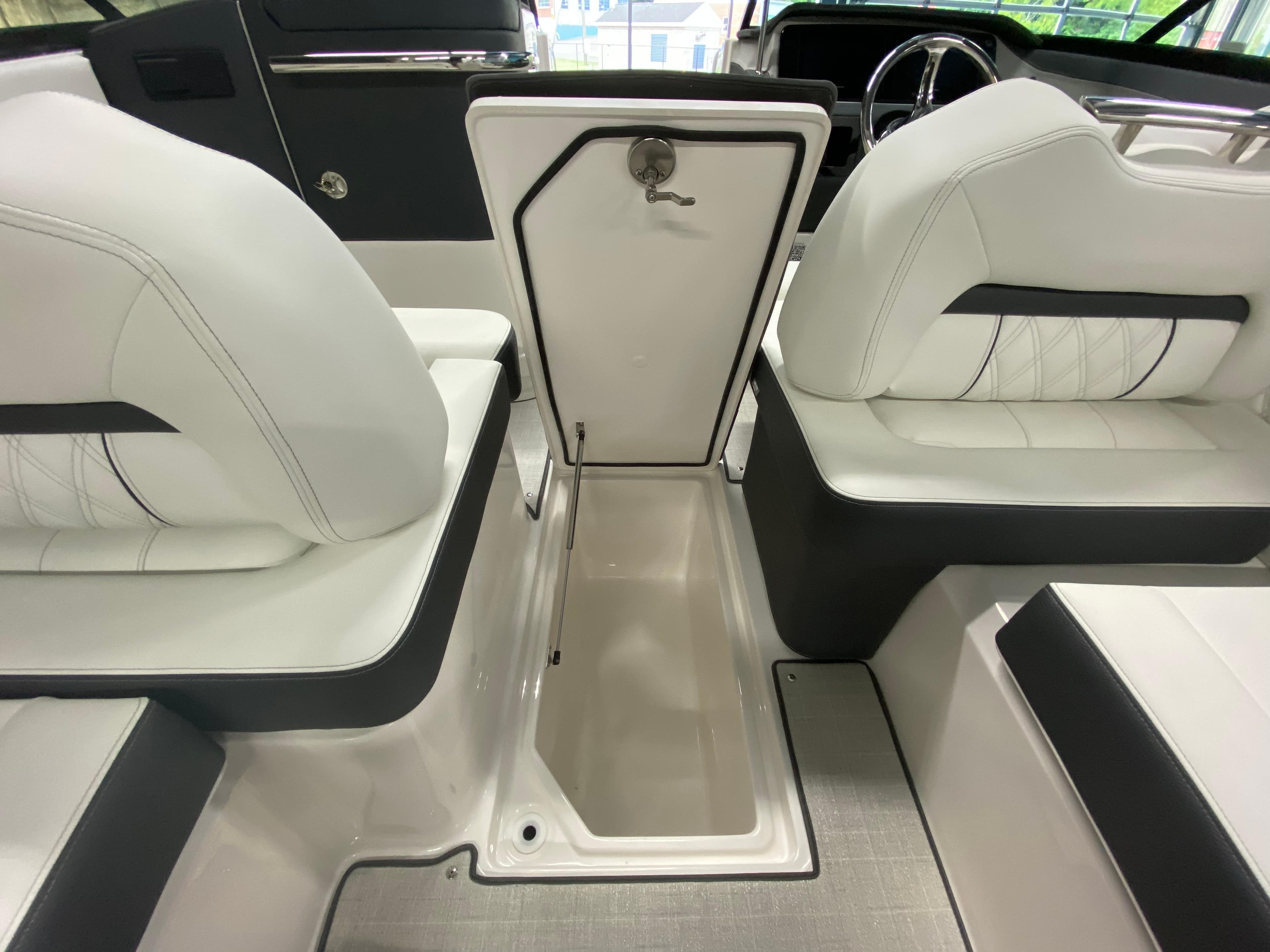 Interior of 2025 Regal LX6 boat showing seating and storage compartment.