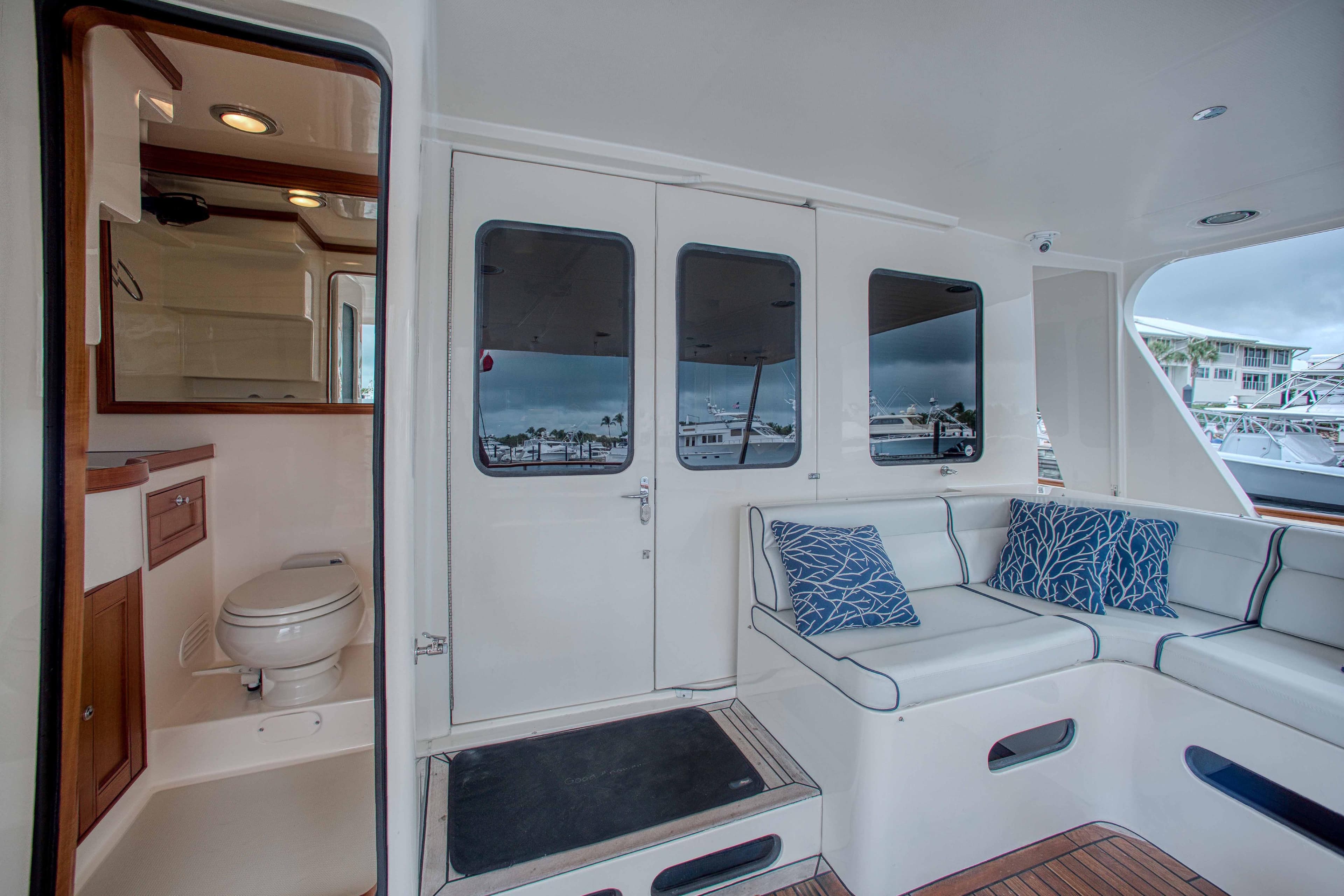 Luxury yacht Marlow 78E 2009 interior with seating and bathroom.
